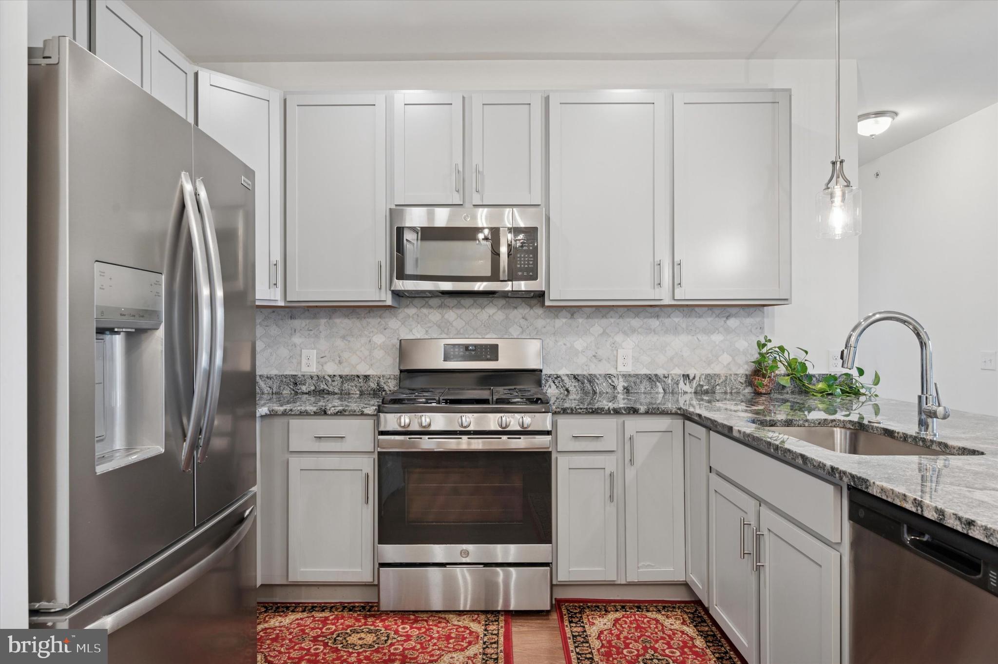 A resale in the beautiful (and newly-constructed) "Residences at Brookhaven Glen" is rare, and only a life change makes this beauty available! No long hallways to travel in this beautiul community as each floor has only 4 condos, so every unit is a corner with lots of windows for so much natural light. This unit is just steps away from the main entry (secured with key fob), and an elevator will take you to this top-floor unit where a lovely open floor plan and 9' dramatic ceilings greet you. A gorgeous, upgraded kitchen boasts 42" cabinets, beautiful granite countertops, ceramic tile backsplash, upgraded faucet, pantry, Progress pendant lighting over the sink/breakfast bar, a stainless steel undermount sink and stainless steel appliances (dishwasher, microwave, refrigerator) are included! The kitchen with it's gracious breakfast bar is wide open the to the dining area (with crown molding and chair rail) and the living room which has sliding glass doors leading to a lovely balcony. (A storage closet is also located on the balcony). The front room can serve as a bedroom (currently used as a den/office), and there are 2 more bedrooms to the back of the condo. The primary bedroom is spacious, has a large walk-in closet and a beautiful full bath with shower, double bowl vanity with granite countertops and a convenient linen closet too. The other bedroom is spacious, has a double closet, and is adjacent to another full, hall bath, also with granite countertops and a shower. All bedrooms have a lighted ceiling fan as well, there are raised-panel doors throughout the unit with custom hardware, luxury vinyl plank flooring everywhere but in the den/bedrooms where there is stain-resistant carpeting .The convenient in-unit, full-size washer and dryer are located in the hallway and are also included. Dont miss the gorgeous courtyard in the rear of the building which includes 2 pergolas, 2 gas grills, a small fountain and a gazebo with rocking chairs for all to enjoy. There is also a private dog park too. Come see! You will not be disappointed! (Conveniently located just minutes from I-95, Route 1, the Blue Route, Media Boro, the airport and lots of shopping and restaurants!)