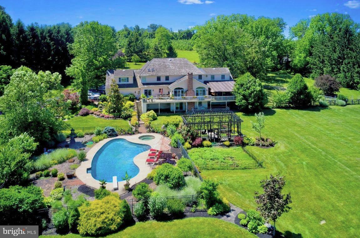 Spanning over 10 acres of pristine landscaping & perfectly manicured meadows is "Hart's Land", an elegantly appointed brick colonial home set within the backdrop of Bucks County. This beautifully maintained property features long spans of pastures and delights with an idyllic swimming pool as Clydesdale horses frolic ever so gracefully in the horizon. The beauty found within this majestic expanse of land provides a natural sanctuary of seclusion from the stresses of everyday life. Â A highlight of this property is the magnificently, custom built iron pergola which looks as though it was transported directly from the Palace of Versailles. Hart's Land is a gardener's paradise; lush botanical plantings & vegetable beds are strategically positioned to attract just the right amount of sunlight. Bring your green thumb to these nutrient rich soils and leave the rest up to Mother Nature.
This Sugan Rd residence was originally built in 1987, expanded in 2015 and has been thoughtfully cared for throughout the years.  The welcoming foyer flows into a bright living room, showcasing high ceilings, fireplace and French doors which open to a generous deck.  The kitchen is lovely and features blackened stainless steel, premium Kitchen Aide appliances, a center island for entertaining and of course, panoramic  views of the entire property. Through the library is the oversized family room, a cozy retreat and part of the newer wing, making it the perfect gathering place to watch a movie and relax.  Enjoy the best of formal and informal living with 4 bedrooms, 4.5 baths, mother-in law suite & partially finished basement. Important to note is this property is also heated & cooled with a Geothermal system which aids in keeping utility expenses below average for a home of this size.  At the end of the day, let the dogs run free in the fenced off side yard and allow yourself to unwind on a back deck which is adorned with a sun protective awning. A short stroll down the paved driveway is a 2 level, 2600 sq ft modern barn which provides ample storage space for all of ones "country-life toys".
The location of Hart's Land is peaceful and private. Quiet country roads lead to New Hope, a charming small town that is thriving with an eclectic mix of modern & historic architecture and a bustling economy. This vibrant small-town community is located along the Delaware River and inspires with award winning restaurants, boutique shopping and is home to the Bucks County Playhouse. A stone's throw away from both Philadelphia and New York City, 2759 North Sugan Rd is conveniently located, easily accessible and has limitless potential. Here, the sun rises & sets with endless views of scenic vistas and the spirit of natural beauty.