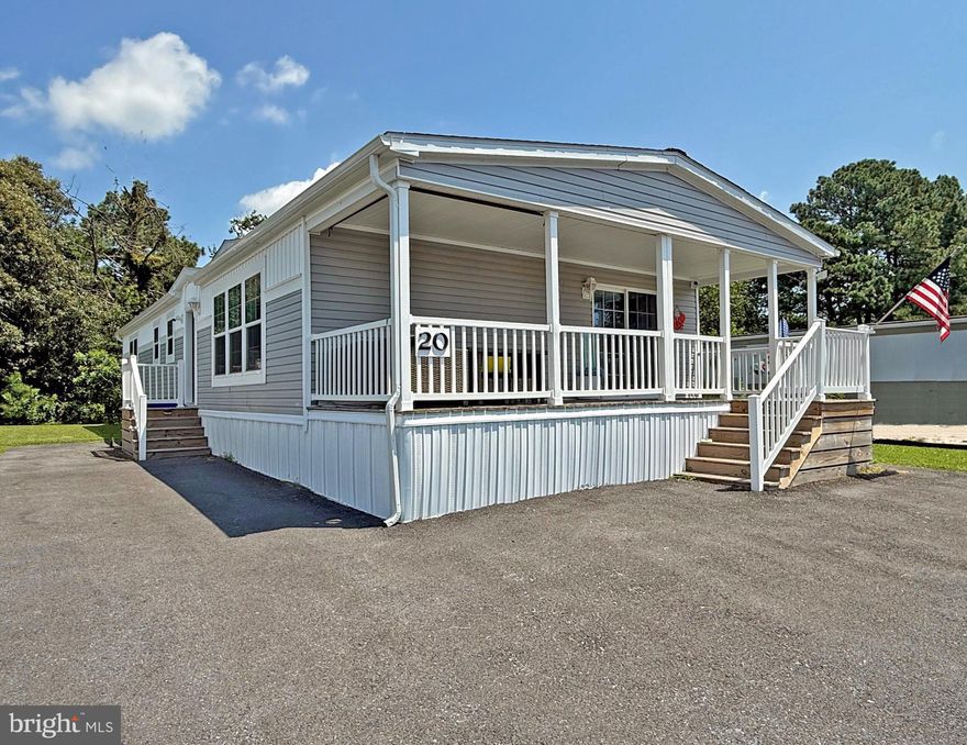 Wow! This 2019 Champion was ordered by Bayside Homes to be their model, but it was sold to these lucky Sellers instead! This home features an all-drywall interior, arched two-panel doors, crown moulding, luxury vinyl plank flooring, and more. The home also has the upgraded “ultimate” kitchen package, and the “super” laundry room option, too. The spacious living room has a ceiling fan and a stylish built-in entertainment center with an electric fireplace. The living room opens to the kitchen. The kitchen has a breakfast-bar island, high-def countertops, tile backsplash, and a stainless steel appliance package. There is a gas range, gourmet range hood with warming racks, a built-in microwave, a fridge with ice maker, and a dishwasher. The dining area adjoins the kitchen, and it has a sliding glass door to the 8’x26’ covered front porch. The main bedroom is at the rear of the home. It has an enormous walk-in closet with swing-out “bookcase” doors. The en Suite bath features a double-sink vanity, open shelving for your linens, and a large step-in shower. The other two bedrooms are generously sized and they share the second full bath, which has a tub/shower. The oversized “super” laundry room has a full-sized, stackable washer & dryer set, with plenty of upper and lower cabinets and a utility sink. The water heater, the 200amp electric panel, and water shut-off valve are located in the laundry room. The foyer coat closet has a trendy barn door. Warm gas heat and central AC with a Nest thermostat. Extra parking for 3-4 vehicles. Partially furnished. No shed, but one could probably be added if you’d like to have one. Rear yard backs up to a wooded buffer, so no backyard neighbors. Colonial East is located in the "Midway" area of Rehoboth, so you'll be an equal distance - about 4 miles - to the Rehoboth boardwalk or the Lewes public beach! And there is a water park, movie theatre, fitness center with racquetball, and restaurants just a short distance from the community. Property is subject to a transferrable, annually-renewable leasehold interest: Lot Rent is currently $895.84/mt. (renews again on March 1, 2026 with any increase capped as per 25 Del. C. Sec. 7050-7054). Lot rent includes membership to the outdoor pool. Trash/recycle and the State’s Relocation Trust Fund (RTF) are extra fees added to the base lot rent.  Buyer pays electric, water, sewer & metered gas (LP). A Park application is required, and a Buyer will be accepted as a Resident based on the following criteria: 1.)income verification, 2.)credit bureau score, plus evaluation of debt-to-income ratio, and 3.)criminal background check. (Note: Rentals are NOT permitted in this community - but friends & family may always visit.) Financing may be available to qualified borrowers from only a very few Lenders that specialize in installment/chattel loans for mobile/manufactured homes on leased land. Closing costs include a real estate transfer tax (3.75% DMV Doc Fee) & a Settlement Agent Fee.