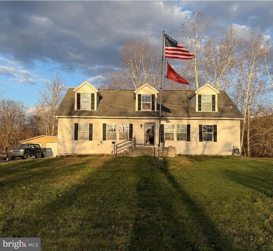 This charming Cape Cod-style home, built in 2006, offers a perfect blend of comfort and functionality with plenty of room to expand, nestled on a generous level 3.18-acre lot in the picturesque woods of Shermans Dale with beautiful mountain views.  This residence is designed for both relaxation and entertaining with 4 spacious bedrooms and 3 full bathrooms. Step inside to discover an inviting open floor plan that seamlessly connects the living, dining, and kitchen areas. The family room, conveniently located off the kitchen, features a cozy propane fireplace adorned with beautiful stone and an aged wood mantel, creating a warm ambiance for gatherings or private snuggle time. The kitchen is a chef's delight, equipped with modern stainless appliances including a gas range, built-in microwave, refrigerator, and dishwasher, complemented by ample counterspace.  There's room for an eat-in area perfect for casual meals or a quaint pub table, or leave the space open and enjoy all your meals in the adjoining formal dining area.  Natural light floods the home, accentuated by recessed lighting and elegant crown moldings throughout the first floor. Attention to detail is evident throughout!  Enjoy the convenience of a main floor laundry and an entry-level bedroom, ideal for guests or multi-generational living. The second floor features 2 spacious bedrooms, a full bath and a large flex space that could be used as an additional family room, office, study or gaming area.  Step outside to your private oasis, complete with an above-ground pool installed in 2025 and a spacious deck, perfect for summer barbecues and relaxation. The detached garage provides ample storage and parking, with additional driveway space for guests.  This home was built with modular construction techniques in a climate controlled site and then assembled on site with a full basement featuring Superior Wall construction making finishing it a breeze.  The basement currently includes a large storage area but could easily be finished to add a huge bonus space.  Heating and cooling options include duel fuel heat and A/C with propane back-up, a mini split system for the 2nd floor, a gas fireplace in the family room and a pellet stove in the living room. This home is not just a place to live; it's a sanctuary where memories are made. Experience the perfect blend of comfort, style, and outdoor enjoyment in this delightful property.