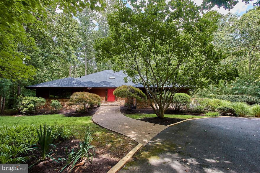 For the nature lover in you, this home has it all!  Absolutely Immaculate!  Located at the end of a private cul-de-sac it is surrounded by trees.  Enjoy the quiet solitude of the Shadowalk neighborhood.  This well maintained Contemporary home offers over 3600 sq ft of living area on two levels.  (Sellers state 4500 sq ft to include baths, closets and hallways). Wood and Stone siding provide a mid-century style elevation plus a brand new Roof with new Skylights!   Stone walkway and porch invite you in through the solid wood front door.  Porcelain Tile floors through the foyer, hall, dining, mud room and kitchen area compliment the style of this home.  One of the best features is the Main level Master Bedroom Suite!  Owners took great pride to update the Master Bathroom which includes the walk in Steam Shower with several  Shower Heads and a bench - all with upgraded ceramic tile!  Relax in the Jacuzzi jetted tub, surrounded with granite counter and two vanity tops and upscale lighting.  Large closets and access to a 2nd bedroom which could be a nursery/office or a dressing room.  Main Level offers an adorable powder room access from hall.  The Great Room was just carpeted.  Also, it has several recessed lights and Two Ceiling fans plus the new Skylight!  The Centerpiece of this room is the Wood Burning Floor to Ceiling Stone Fireplace!  Sunshine streams in through the two sliding doors. The Vaulted Ceilings are all hardwood- for a unique contemporary look!  Sliding doors to the Upper Deck which overlooks acres of trees. The Dining Room has an exquisite light fixture and mirrored walls adding depth.  The Chef's Kitchen features Upgraded Cabinets, Granite Counter tops and Stainless Steel Refrigerator - even a trash compactor!  The Center Island adds extra storage and a Stove w/a Cook Top.  Each cabinet offers slide out drawers.  Off the kitchen is a screened porch - a perfect serene place to enjoy your morning coffee.  Super large Laundry/Mud Room with Built in ironing board, extra cabinets, a work area desk with Granite counters and the 2nd access to garage.  Walk down to lower level to discover three more Bedrooms and two Full Baths.  Some rooms have been freshly painted.  Lots of storage in the utility room!  There is another office/den or could be a wonderful work out area.  Ceramic tile makes this rec room great for parties and wet feet coming in through the Sliding door from the pool deck.  There is also room for an eat in table to complete the wet bar.  The rear yard is surrounded by privacy fence and retaining walls, creating total privacy while you enjoy hours in your pool!  Home inspection completed and repairs made.  This home is "turn key ready" for even the pickiest buyer!