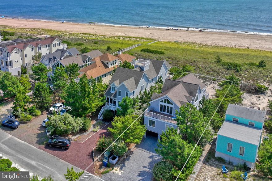 Oceanfront home in North Bethany, perfectly situated within the exclusive gated community of Ocean Village. Boasting 42 feet of pristine ocean frontage on one of the larger lots in the community. This home offers breathtaking ocean views and easy access to a private beach with lifeguards. Step into the great room where floor-to-ceiling windows flood the space with natural light, leading to an expansive main deck- ideal for entertaining, relaxing, or simply taking in the unobstructed Atlantic Ocean vistas. The open floor plan is complemented by hardwood flooring, seamlessly connecting the kitchen, dining area, and family room. The expansive kitchen features a long countertop bar and generous cabinet storage, perfect for culinary enthusiasts. The main level also includes three spacious bedrooms and two full bathrooms. Upstairs, you will find an expansive oceanfront master suite with a private deck, en-suite bathroom with jacuzzi, walk-in closet, and double sink vanity. An additional master suite also offers its own private deck, en-suite bathroom, walk-in closet, and double sink vanity. Fully furnished and designed for comfort, this home is an ideal beach retreat and smart investment property with a strong rental history. Rental investment analysis available upon request. Adjacent property available. Additional details available upon request. Enjoy the security of the property’s high elevation and natural dunes. Features include vaulted ceilings, oceanfront dining areas, two large oceanfront decks and newly installed air conditioning units. The lower-level offers two outdoor showers, a large beach accessory storage room, a tranquil covered sitting area, and abundant parking that can accommodate up to 10 vehicles in the driveway and carport. Experience coastal living at its finest. Call for a private tour today and see the potential of this extraordinary oceanfront property!