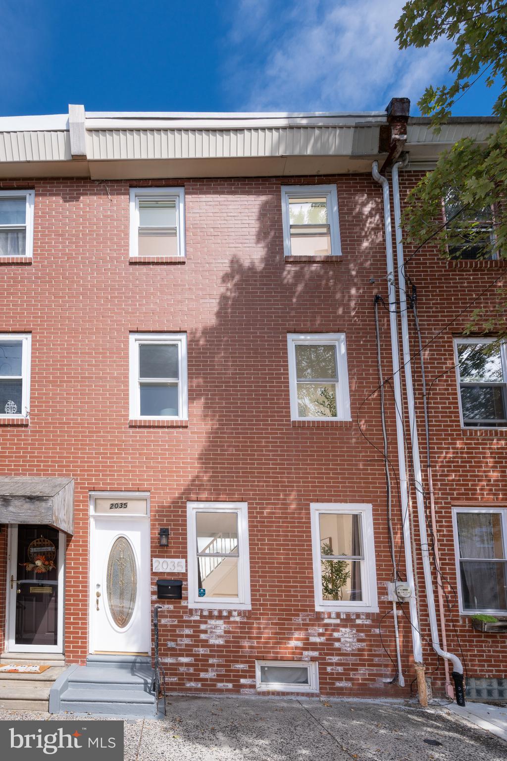 This three story townhome in Fishtown/Olde Kensington is a gracious 15' wide and features recessed lighting on the first floor and hardwood flooring throughout. The ample living room greets you with two oversized windows and a transom above the privacy glass front door. A staircase with arch divides the living and dining rooms. A convenient half bath is located here. The kitchen features high ceilings, large windows, wood cabinets, a pull down sprayer faucet, and stainless appliances, including French door refrigerator with ice maker and filtered water dispenser, dishwasher, 5-burner gas range, and vent hood. The oversized bi-level rear yard features a huge patio area great for a dog to romp or to host a get together. On the second floor there is a fully tiled bathroom with soaking tub, glass shower, and double sinks. The laundry area, just behind it, features a front-loading washer and dryer set, linen closet, and window. The main bedroom on this floor has two large windows, a new ceiling fan with light, and custom built-in drawers and closet system. The third floor is home to the second and third bedrooms, each with new ceiling fans and closets, and can both accommodate queen-sized beds. This home has a sump pump in the basement, central air, is freshly painted, and ready to make it your home!