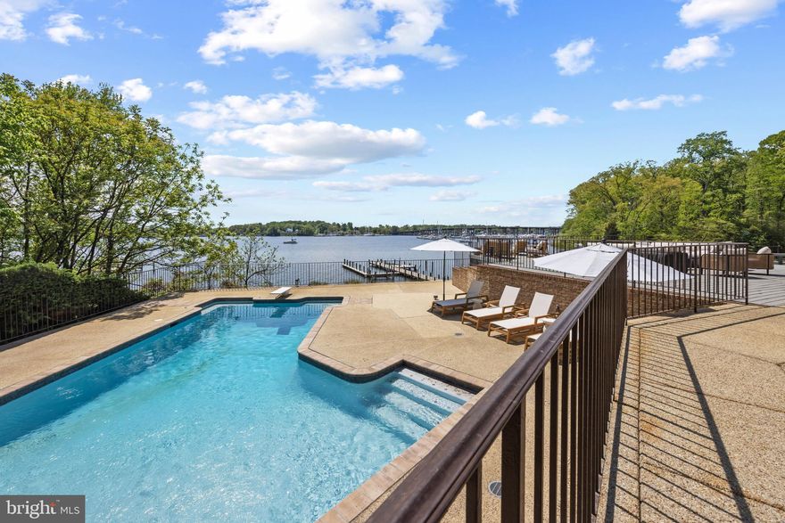 Panoramic views over the South River set the stage for a truly elevated waterfront lifestyle, where the expansive rear deck and resort-style pool create a seamless connection between the home and its breathtaking surroundings. The deck becomes a natural extension of the living space, perfect for morning coffee, sunset entertaining, and everything in between, while the pool offers a private, resort-like setting that enhances every moment spent outdoors. Just beyond, the screened porch is thoughtfully designed for effortless entertaining, providing a comfortable, all-season retreat with sweeping water views.

Set on 2.83 acres in the sought-after Poplar Point community, this all-brick residence is carefully positioned to capture the beauty of its surroundings, with panoramic river views. Inside, the home offers a wonderful balance of open gathering spaces and private retreats. The chef’s kitchen, dining area, and spacious office provide both function and flexibility, while the inviting and spacious living room with access to the rear deck creates the perfect balance of indoor and outdoor living. Four generously sized bedrooms, each with an ensuite bath, ensure comfort and privacy throughout.

A thoughtful layout continues with dual staircases enhancing the home’s flow. A rear staircase leads to an additional family space, ideal as a media room, lounge, or playroom, while the main staircase ascends to the private bedroom level. The primary suite is a true sanctuary, featuring multiple balconies that overlook the pool and South River, creating a constant connection to the water. The suite itself offers expansive proportions, including a large walk-in closet, a beautifully scaled primary bath, and a distinctive sunken sitting room, perfect as a quiet escape or private lounge.

The lower level adds versatility with a one-bedroom apartment complete with its own entrance, while a separate carriage house provides additional garage bays and a private one-bedroom living space with kitchenette, ideal for guests or extended stays.

Outdoors, the meticulously maintained and fully fenced grounds gently transition toward the water, enhanced by a discreet vehicle path that allows for convenient access to the shoreline. A newly renovated deep-water dock features multiple slips, lifts, a fishing pier, and a dedicated crab deck. The perfect set up for delivering an exceptional boating experience. 

From poolside afternoons and evenings on the porch to days spent out on the river, this property offers a rare combination of scale, comfort, and a truly immersive waterfront lifestyle. Welcome Home!