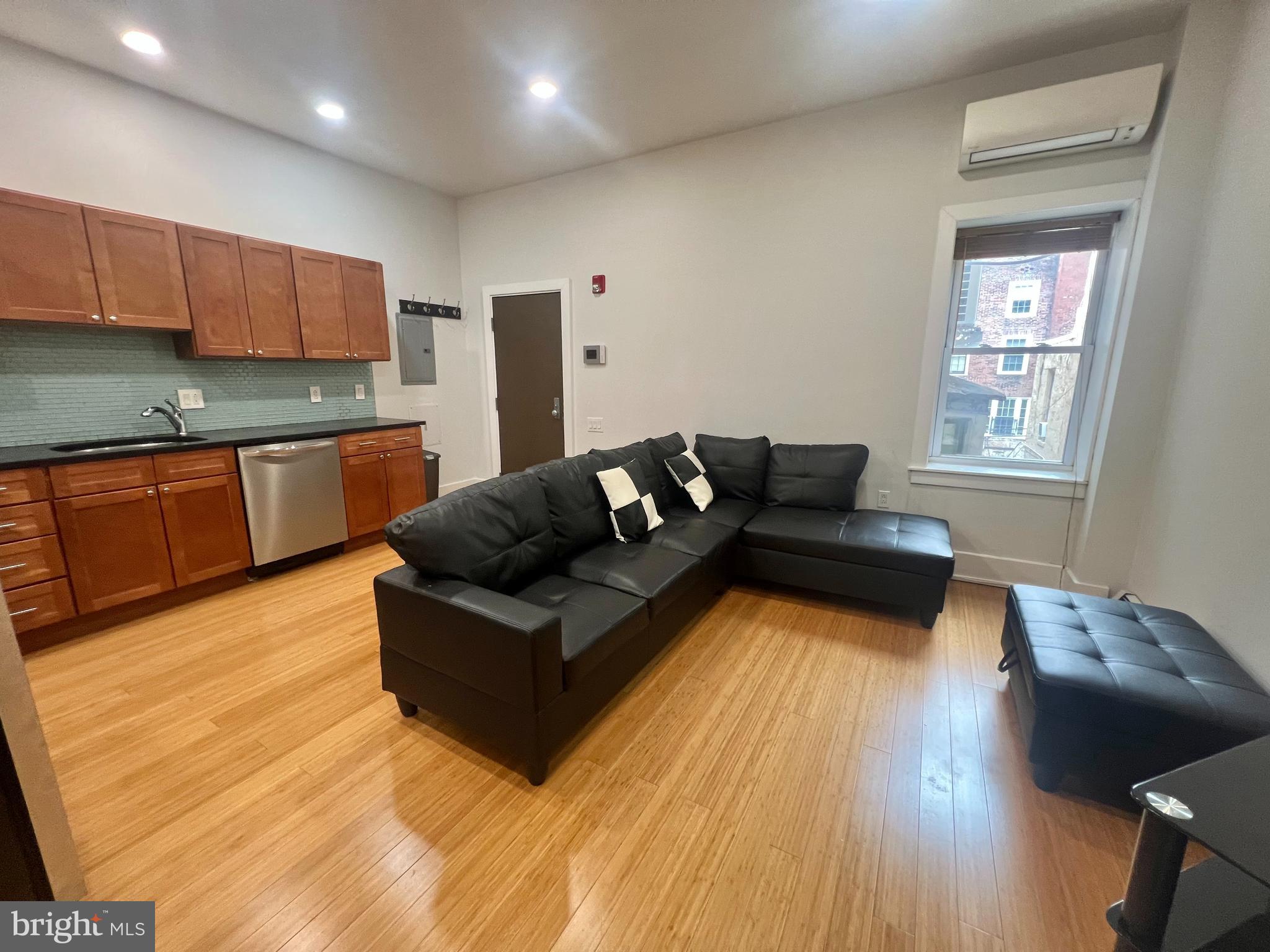 Welcome to 1902 Pine St, Unit 2F — a modern 1-bedroom, 1-bathroom condo nestled in the highly desirable Rittenhouse Square neighborhood. This beautifully updated unit offers a perfect blend of modern design and classic charm. Step inside to discover bamboo flooring and 9-foot ceilings throughout. The sleek kitchen is outfitted with honed black granite countertops, a stylish glass backsplash, stainless steel appliances, and warm wood cabinetry. The bathroom boasts luxurious touches including a custom glass shower enclosure, chrome rainwater shower head, white Thasos marble finishes, vessel sink, and wall-mounted faucet. Enjoy the convenience of free shared laundry located in the basement, maintained and paid for by the condo association, and if desired, this apartment can come furnished. The location itself can't be beat — just blocks from Rittenhouse Square, Avenue of the Arts, and countless coffee shops, restaurants, bars, and parks. With easy access to public transportation and the Penn Bus, everything Philadelphia has to offer is right at your doorstep. Don’t miss your chance to live in one of the city’s most vibrant and walkable neighborhoods in a sophisticated and modern space.