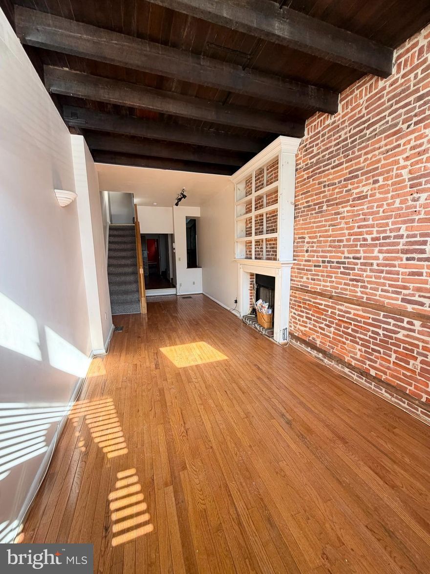 Centrally located in the heart of Canton, this spacious home offers approximately 1,898 square feet of character and comfort. The main level features an open floor plan highlighted by exposed brick, wood beams, wood floors, and a cozy wood‑burning fireplace. A long, well‑designed kitchen flows into a side dining area, creating a unique and inviting space for everyday living and entertaining. A convenient half bath completes this level. The second floor includes two bedrooms, a full bath, and a separate laundry room. The third floor is dedicated to the primary suite, offering privacy, generous space, and access to the expansive rooftop with sweeping city views. With its distinctive charm, thoughtful layout, and impressive square footage, this home delivers the best of Canton living. ****Professional photos will be uploaded on Saturday, 02/14****