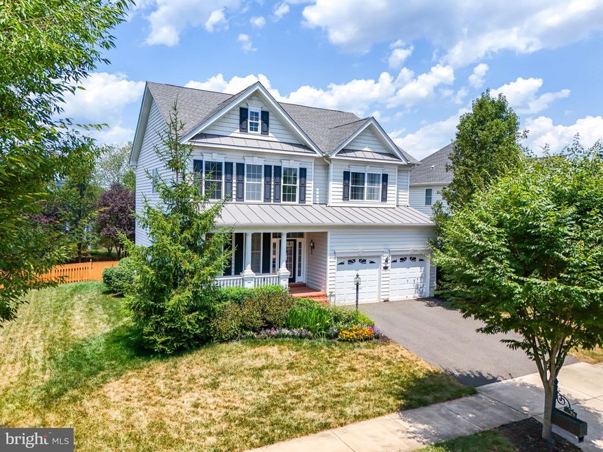 Welcome to this stunning 3960 sq ft home, offering divine living across two levels. This light-filled residence features 4 bedrooms and 4.5 baths, encompassing nearly 4000 sq ft of space. Enter through the formal entryway into the main level, where you'll find a living room, separate dining room, laundry room, and powder room. The open kitchen with a spacious island flows seamlessly into the adjacent dining space and formal living room with a gas fireplace. Step out onto the expansive double-level deck, perfect for lounging and dining while enjoying sunset views over the large, fully fenced backyard.
Upstairs, the primary suite includes His & Hers walk-in closets, wood floors, vaulted ceilings, and a sitting area. The spa-like bathroom features a double vanity, deep soaking tub, and separate shower. Guestroom 1 boasts a full en-suite bath, while guest bedrooms 2 & 3 share a full bath. Each room offers ample storage, with custom built-in closets in guestroom 3.
Additional features include custom blinds throughout, a spacious basement with high ceilings, a full bath and built-in sound system (as-is). Recessed lighting illuminates the expansive living area, which includes a walk-up exit. 
There is the ease and comfort of a 2-car attached garage as well as parking for 2 additional cars.
Located in the gorgeous Dominion Valley Country Club, just a short walk to Gravely Elementary and the Waverly Club House. Residents enjoy world-class amenities such as an Arnold Palmer Signature Golf Course, a renovated Clubhouse, a state-of-the-art Sports Pavilion, 5 swimming pools (including an indoor pool), tennis & basketball courts, playgrounds, miles of walking/biking trails, and two fishing ponds. This residence is also served by award-winning schools, making it an ideal place to call home.

HVAC 2023  HWH 2021 Roof
Microwave conveys as-is
Fridge in garage conveys