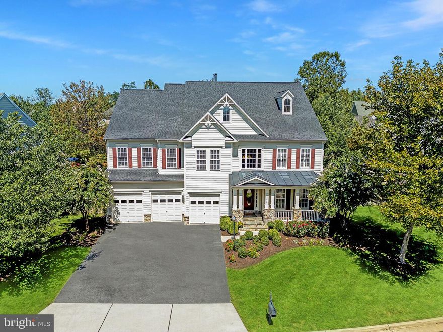 Discover this meticulously designed, well-appointed Van Metre Faulkner model, offering over 6,200 square feet of sheer luxury and elegance. Nestled in the sought-after Broadlands community, this stunning home features five bedrooms, five full baths, and one half bath, presenting a perfect blend of sophistication and comfort for modern living.  
<br><br>
Upon entering, you are greeted by a grand two-story foyer that sets the tone for the rest of the home. The main level showcases rich hardwood floors throughout, upgraded trim work, and a seamless flow between formal and casual living spaces. A two-story family room with a cozy fireplace and built-ins invites relaxation, while the formal living and dining rooms provide the ideal space for entertaining.  
<br><br>
The gourmet kitchen is a true showpiece—beautifully updated with crisp white cabinetry, striking white quartz countertops, and a suite of newer, high-end stainless steel appliances. A timeless subway tile backsplash is complemented by elegant gold-toned fixtures, adding a refined touch of sophistication throughout. The oversized center island serves as both a stunning focal point and a functional gathering space, offering ample seating and prep area for effortless entertaining.
<br><br>
Designed with both style and flow in mind, the kitchen opens seamlessly to the sun-drenched morning room, where atrium windows invite in abundant natural light and create a bright, airy ambiance. Fresh, modern paint enhances the home’s polished aesthetic, while a well-appointed butler’s pantry provides additional storage and convenience—perfect for hosting and everyday living alike.
<br><br>
The main-level home office is equally impressive, boasting custom built-in desks and detailed trim work, along with access to a full bath and a walk-in closet—making it an ideal space for remote work or easily serving as a private main-level guest suite.
<br><br>
Upstairs, the primary suite is a true retreat, with a tray ceiling, two spacious walk-in closets, and a serene sitting room. The spa-like ensuite bathroom offers a double vanity, a luxurious soaking tub, and a frameless glass shower. The upper level also includes three additional bedrooms—one with a private bath and two that share a Jack and Jill bathroom, ensuring comfort and privacy for all.  
<br><br>
The fully finished lower level offers endless possibilities for entertainment and relaxation, featuring a recreation room with custom built-ins, a home gym, a stylish wet bar with a beverage fridge and dishwasher, and a den perfect for guests. Step outside to a beautifully designed patio complete with a built-in outdoor kitchen, gazebo with a fireplace, TV, and heaters—ideal for year-round outdoor living.  
<br><br>
Living in Broadlands provides access to a vibrant lifestyle with community events, three pools, sports courts, fitness centers, and miles of walking trails. The location offers quick access to major commuter routes, silver line metro, highly-rated schools, parks, shopping, and dining options. This home combines elegance and practicality in one of the most desirable neighborhoods in Loudoun County. Welcome to your new home—where luxury and comfort meet in perfect harmony!