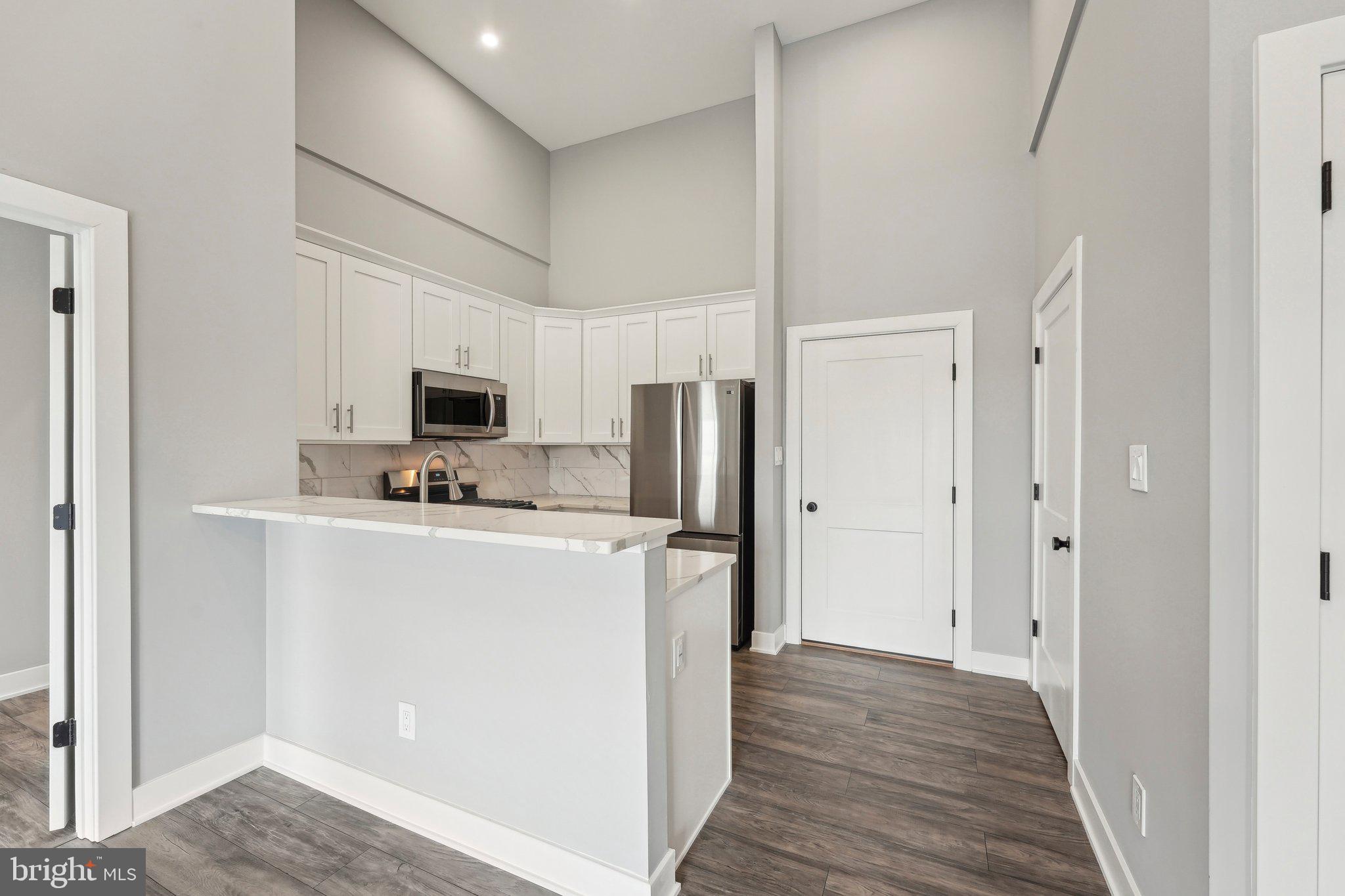 Nestled at 2421 Bristol Road in the heart of Warrington, Pennsylvania, The Warrington Place is a thoughtfully crafted residential community that blends upscale finishes, modern conveniences, and timeless style. Offering one-, two-, and three-bedroom apartment homes, the property is designed to meet the needs of today’s renters who value both form and function in a refined, suburban setting.
Inside each residence, you’ll find open-concept floorplans that maximize natural light and flow, creating a welcoming atmosphere ideal for relaxing or entertaining. The apartments feature soaring nine-foot ceilings and oversized windows, enhancing the sense of space. Gourmet kitchens are outfitted with sleek stainless steel appliances, white shaker-style all-wood cabinetry, quartz countertops, subway tile backsplashes, and oversized islands or breakfast bars in select layouts—perfect for morning coffee or evening meals. Luxury vinyl plank flooring throughout the main living areas adds a stylish, durable touch, while plush carpeting in the bedrooms provides cozy comfort.
Each apartment also includes smart Samsung appliances such as in-unit washers and dryers, allowing residents to handle laundry at their convenience. Spacious bathrooms feature modern vanities, chrome fixtures, and tiled showers or deep soaking tubs. Large walk-in closets provide generous storage, and private balconies or patios in most units offer a quiet space to enjoy the outdoors. Select homes offer premium views or corner locations for even more natural light and privacy.
Beyond the units themselves, The Warrington Place provides a well-maintained environment with controlled access entry, ample private parking, and professional on-site management. The community is located at the intersection of Bristol Road and Route 611, giving residents unbeatable access to major retail destinations and everyday essentials. Whole Foods, Wegmans, Giant, Target, Walmart, Costco, Amazon Fresh, and ShopRite are all within a short drive, making errands quick and easy. Public transportation is also convenient, with a nearby SEPTA bus stop offering a simple commute for those who prefer not to drive.
Warrington itself offers a charming, residential atmosphere with the conveniences of modern suburbia. Residents will enjoy close proximity to a variety of restaurants, local parks, fitness centers, and entertainment venues such as the Regal Cinema. The area is known for its peaceful streets, well-maintained green spaces, and an easy-going pace that makes coming home feel like a true retreat.
The Warrington Place is more than just a place to live—it’s where style meets substance, and convenience meets comfort. Whether you're a busy professional, a downsizer, or someone seeking elevated suburban living, this community delivers a lifestyle that feels both luxurious and effortless.
** Photos are of model units ** Pricing and availability subject to change on a daily basis **
