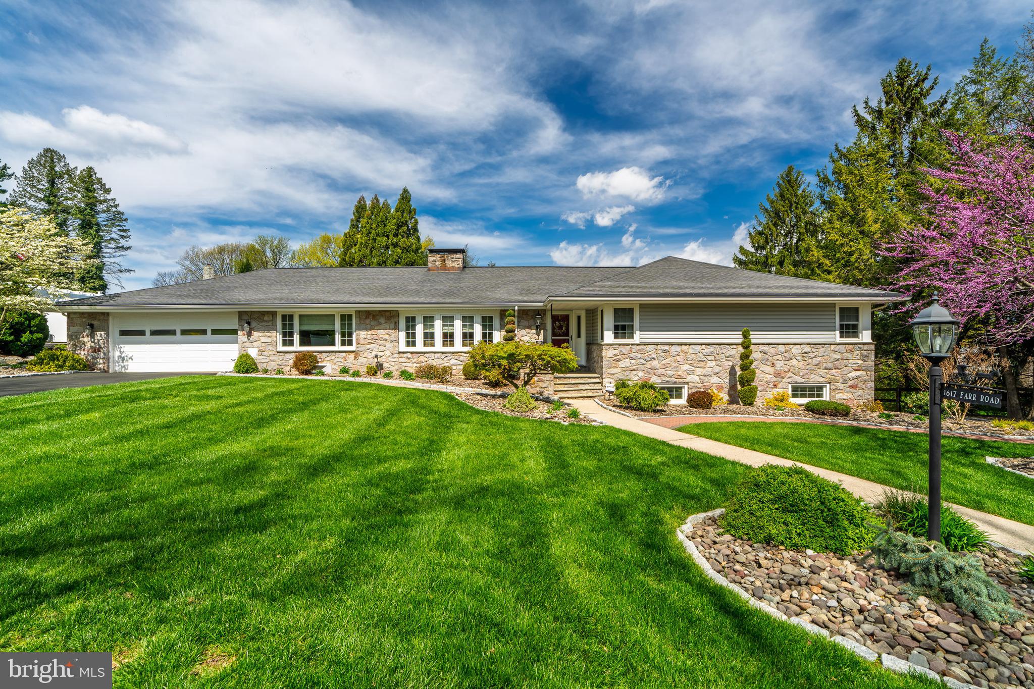 Wyomissing ‘Birdland’ Rancher
This spacious stone rancher with 4 bedrooms, 2 1/2 baths, laundry and 2 car garage on main level has been completely updated. The home has been meticulously cared for and has many extras. The 41 handle kitchen with tile floor is perfect for entertaining with its 10 foot island containing both a wine and beverage refrigerator. It also includes a walk through butlers pantry to the laundry room. The lovely main floor living area has hardwood and tile with a stone foyer. It is accented by a beautiful double sided stone fireplace with custom made mantels and built in shelves. This home is move in ready with its neutral color palette.
The first floor leads out to a large covered porch and a gorgeously landscaped/hardscaped yard enclosed with a fence. The lower level is comprised of a walk out in-law suite. This suite incorporates 2 generously sized bedrooms, full bath and a 26 handle full kitchen. It is rounded out with its own laundry area, lots of closets and storage space as well as a walk out to a covered porch. A stunning ‘Pebble sheen’ salt pool with granite coping was recently updated and all this is accented by elegant mature landscaping, completing the backyard oasis. There is a secluded feel even though you are only minutes away from conveniences. This turn key home awaits .