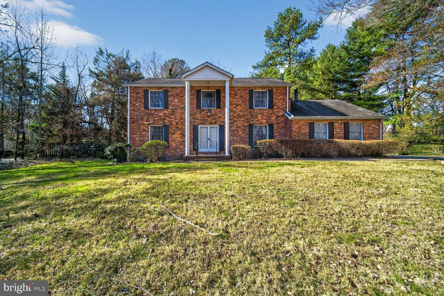 Welcome to this 1979 Colonial set back on a picturesque 2.04-acre lot in sought-after Davidsonville.  This home offers a strong opportunity for investors or buyers seeking value and customization potential.  Step through the double entry doors into a warm and inviting interior with a classic floor plan that flows seamlessly from room to room. The spacious living room leads to a large eat-in kitchen and family room with a wood-burning fireplace.  The  formal dining room ideal for entertaining and a powder room complete  the main level.  On the upper level you will find a large primary bedroom with a sitting area, ensuite bath and walk in closet, two additional bedrooms and a full bath.  The large unfinished basement walks out to the picturesque lot.  A long private driveway leads to an attached 2-car garage. Being sold as-is, this property presents a rare opportunity to customize and elevate a stately home in a premier private setting.  This home is located minutes from major roadways including Rte 50, I-97, Rte 301, and Rte 214.