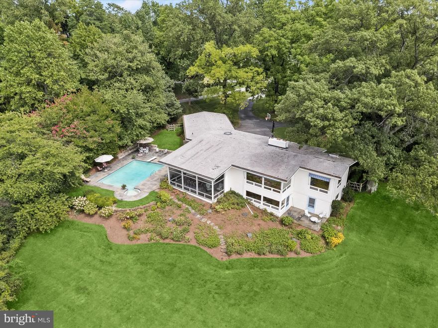 A hidden gem sits quietly back from the road on two extraordinary acres of prime waterfront property.  Offering spectacular views of the Magothy River from virtually every room, this vintage mid-century modern house has gorgeous custom wood paneling throughout with parquet floors on most of the main level. Enter the front door to an attractive center hall that opens to a Great Room with fabulous, panoramic water views of the Magothy and a large wood-burning fireplace. Separated from the Great Room by a striking staircase and brick divide is a handsome Dining Room also looking over the Magothy.  Adjoining the Dining Room is an attractive Galley Kitchen with a breakfast nook with the swimming pool beckoning in the back. Three ensuite bedrooms are located on the main level.  
Descend the switch back staircase to a large screened in porch from where one can descend to the large backyard with splendid plantings and swimming pool. The Lower Level boasts a generously sized Family Room with a wood burning fireplace and lovely water views and door opening to an outdoor patio. This level is complete with two additional ensuite bedrooms, a recreation room, a built-in vintage kitchenette, a laundry room, a large storage hall and utility area room.
With enormous privacy on the waterfront side, there is a carport with access to the main house and plentiful parking in the front. 


Information on Gibson Island:

Gibson Island is a private island within one hour of Washington, D.C. and Baltimore offering an absolutely extraordinary setting.  The Island comprises 1000 acres with seven miles of shoreline. Two thirds of the Island is undeveloped and is owned by the Gibson Island Corporation, the homeowners' association.  The remaining third is residential home sites. 

Gibson Island is located on the western shore of Maryland, so there is no need to cross the Bay Bridge. On the Island is a 43-acre spring fed freshwater lake in which one may enjoy non-motorized watercraft activities such as paddleboarding, canoeing, kayaking, fishing and swimming.  

The Island offers enormous privacy and security--there is an entry gatehouse staffed 24+Hours and the Island is patrolled by the Gibson Island Police Force (GIPD).  The Gibson Island Corporation Service Department offers yard maintenance and landscaping and other services for homeowners.  There is a full-service yacht yard.   From the Island, it is just a 20-minute drive to BWI Airport and the neighboring Amtrak train station.  

The Island houses a private country club (membership by invitation) offering yachting, fine dining year-round, tennis, an award-winning Charles Blair Macdonald designed 9-hole golf course, swimming, croquet, skeet shooting, and more.  (C)