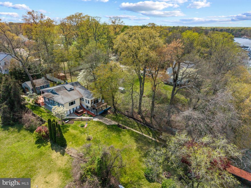 Welcome to your waterfront haven along Stoney Creek! 

Perfectly positioned along a tranquil stretch of shoreline, this exceptional property offers the ultimate blend of relaxation, recreation, and refined living. From the expansive upper-level deck with sweeping water views to the covered patio ideal for outdoor dining, every space is designed to take full advantage of the stunning setting. Follow the beautifully landscaped grounds down to your own sandy beach and cozy fire pit. A two-tiered private pier with a never-used boat lift awaits, making it effortless to set out for a day on the water or sunset cruise along the creek. End your evenings unwinding in the hot tub as you take in panoramic waterfront views.

Inside, the home is equally impressive. Thoughtfully maintained and updated, it features spacious living areas and a seamless indoor-outdoor flow perfect for both everyday living and entertaining. The main level showcases recent updates and modern finishes, while renovated bathrooms add a touch of luxury throughout. Additional upgrades, including a basement French drain with a lifetime guarantee and a detached garage with generous storage, provide both comfort and peace of mind.

Tucked away in a serene setting yet conveniently located just a short drive from BWI Airport and Baltimore, this property offers the best of both worlds.

Whether you’re searching for a full-time residence, weekend escape, or investment opportunity, this rare waterfront gem delivers an unmatched lifestyle.

Schedule your private showing today and experience Maryland waterfront living at its finest.