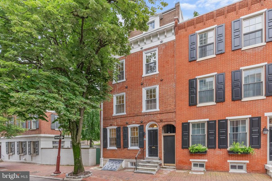 On offer is a rare chance to own a meticulously renovated luxury residence in the heart of Philly's sought-after Society Hill neighborhood. This large, 4-story home boasts 4 bedroom suites totaling 4 full and 3 half bathrooms, a finished basement, multiple outdoor spaces, a bonus kitchenette, dual-zone HVAC, distinctive details throughout, and placement in the top-rated McCall School catchment. A historic block lined with mature trees and a brick sidewalk leads to 202 Spruce St's towering red brick facade. Inside, a vestibule ushers you into the open, bright, and airy main level, framed by hardwood floors and soaring ceilings. A pair of windows at the front illuminates the living room, where there's plenty of space for hosting guests. At the center is a gleaming, all-white gourmet kitchen fitted with custom shaker cabinetry, waterfall counters, high-end stainless steel appliances, brass fixtures, and a massive island with seating. A powder room sits by the staircase. Completing this level is a sun-soaked dining room showcasing dramatic 2-story ceilings and a wall of windows. Sliding doors open to the secluded patio, making indoor/outdoor entertaining a breeze. This peaceful space can be transformed into a private oasis perfect for relaxing away from the city's hustle. More living space, along with another powder room, is found in the expansive finished basement, ideal for a family room, gym, or hobbies. On the home's second level, there's a study area off the staircase that overlooks the dining room. Past one of two laundry closets, a hallway leads to the bright, spacious primary suite that features tall windows, two bespoke closets, a bonus flex space that could act as a dressing area, and a hotel-like bathroom adorned with a double vanity, linen cabinets, and a glass-enclosed rainfall shower. Up on the third level, a kitchenette and a powder room are by the stairs. A shady terrace off the rear is another outdoor spot where you can hang on good weather days. A second, large bedroom suite completes this level. Topping off the home are two more bedroom suites, an additional laundry closet, and a pair of balconies. 202 Spruce St's utilities include central a/c, gas heat, and electric hot water. This property also includes a 10 year tax abatement! In addition to everything inside, this fantastic location earns a Walk Score of 94! Top restaurants, friendly shops, popular markets, and lively entertainment fill the surrounding blocks. Nearby, Penn's Landing hosts holiday events and Spruce Street Harbor Park along the riverfront is a go-to destination all spring and summer. Neighboring Old City has lots to explore, plus idyllic Washington Sq Park, Pennsylvania & Jefferson Hospitals, and Center City are all within walking distance. There's also easy access to Columbus Blvd, I-95, I-676, and South Jersey. Schedule your tour today! Square footage amount includes finished lower level.