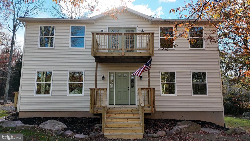 Ideal as your forever home or a lovely, wooded vacation retreat, this home offers an abundance of living space over its three levels and opportunity for outdoor living! The main level boasts ample living and entertaining space with its living room, sprawling updated eat-in kitchen, updated full bath, and formal dining room! Upstairs, a primary bedroom features updated ensuite with soaking tub as well as three bright bedrooms and updated hall bath with double vanity! An upper-level balcony sits to the front of the home. The lower level begins with a spacious family room and offers two further bedrooms!  A utility and storage space welcome functionality. Mature trees and natural surroundings can be enjoyed from the front porch and rear deck! The private community is situated in excellent proximity to beautiful Jim Thorpe as well as the many attractions of the Pocono Mountain region, all just a short drive from the PA Turnpike. With its updates galore and potential for short term rentals, this home is a must see! Note: listing agent is related to seller.