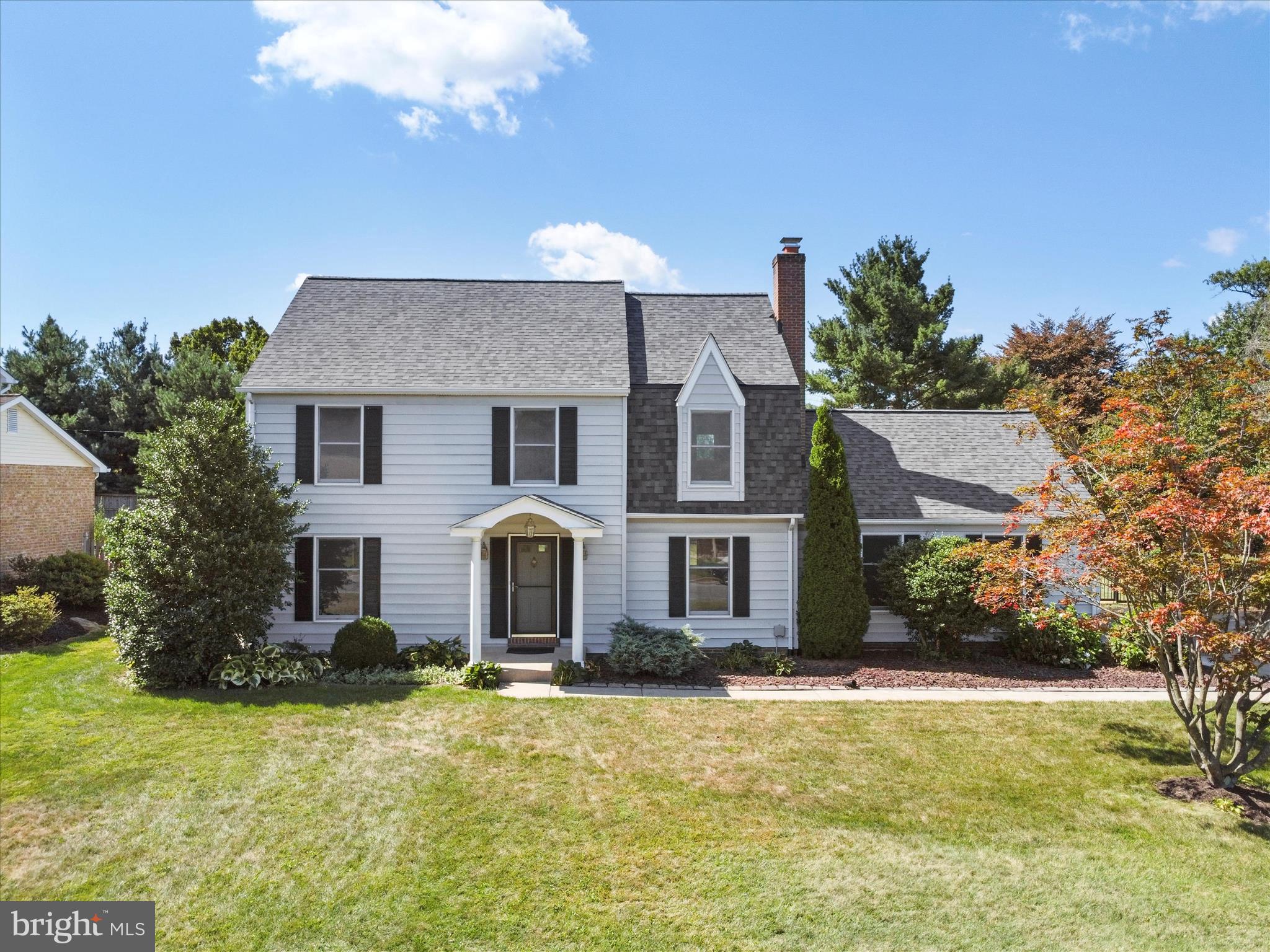 Immaculately maintained and tastefully updated, nearly 3,000 sq. ft. four bedroom, two full, and one half bathroom colonial nestled in sought after Woodmere North neighborhood and conveniently located within walking distance to schools, the park, shopping, and restaurants. The light and bright climate controlled all-season sunroom is the perfect place for reading and relaxing. Walk right out onto the large concrete patio and enjoy the private and fully fenced in back yard. The kitchen is fully equipped and has a large eat-in/breakfast area for table and chairs. Separate formal dining room has crown moulding, chair railing, and is easily large enough to entertain guests and family. The family room has a woodburning fireplace. Primary bedroom has a huge walk in closet and a private bathroom with double bowl sinks and ceramic tiled walk-in shower. The full basement is partially finished and features a bonus room that can be used as an office, or as a hobby, gaming, or exercise room. Separate laundry room with washer and dryer included, and a huge storage room. The oversized attached two car garage has pull down attic stairs for extra storage space. Brand new architectural shingle roof just installed. This home truly checks off all the boxes. Close proximity to golf courses, wineries, local shops, and fine dining. Ideal commuter location within just a few short miles to I-70 and the MARC train. Sellers will provide a 1-year home warranty. Schedule your showing today!