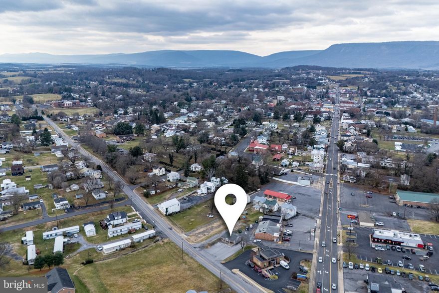 Commercial Zoned Building w/ Vacant Lot! Commercial zoned property one block off of main street! The building is just over 750 sq. ft. and in good condition! Laminate flooring throughout, half bath, recessed lighting and tasteful paint colors! Vacant lot is included in this sale! Great opportunity!