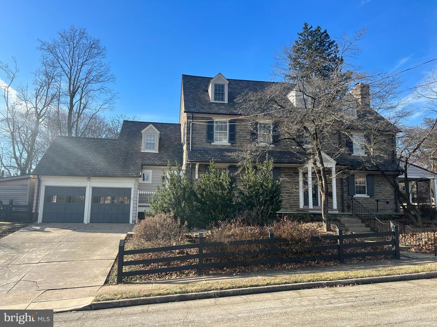 Please check back next week for professional photos! Welcome to 7606 East Lane in coveted Wyndmoor……The inviting curb appeal of this stately residence is perfectly poised on a corner lot, above the street, while luring guests with mature landscaping, and beautiful architectural details.  Spanning over 4,200 square feet, this residence features 6 bedrooms, and 3.5 baths of open concept living throughout this tastefully renovated classic center hall colonial. This extraordinary property is the perfect combination of elegance & comfort making it easy to accommodate today’s busy lifestyle while retaining the charm & historic features. Enter the main level with a bright wide grand center hall Foyer with wood floors and a view of the rear through the French doors that open to the conservatory. The newly renovated Kitchen is a chef’s dream with Carrera marble countertops & massive center island, floor to ceiling soft close cabinets with Emtek hardware, top of the line stainless steel appliances, double oven, Homerwood hardwood flooring, a newly installed picture window, and a butler’s pantry. The elegant Dining Room is complete with crown molding, and large windows. The large, sophisticated Living Room has a wood burning fireplace with a brick surround, two sets of French doors to the side covered porch, and recessed lighting. The rooms of the main level can be used as individual rooms but has a fluid layout for entertaining. The Main Level also includes a separate room that can be used as a home office or den, a half bathroom, and a mud room.  The first Upper level of the fantastic home features a generous Owner’s suite with a renovated bathroom with Carrera marble tile flooring, an oversized marble shower with a rain shower system, double vanity, a renovated walk-in closet with custom built-ins & shelving (previously a bedroom) and doors to a sunroom. This level also has another sizeable bedroom with a sitting room & renovated walk-out porch with newer flooring & railing, a newly installed laundry room (previously a bedroom), and a hall bathroom with restored historic subway tile, new marble flooring, and a new pedestal sink. There is a convenient back staircase for ease to the kitchen.  The third floor will not disappoint with offerings such as two giant bedrooms, one with a new walk-in cedar closet, and a refreshed hall bathroom.  The basement is perfect for entertaining presenting hardwood flooring, a refinished bar with vintage Gretz copper taps & ice cabinet, and built-in wine cabinet for storage.  There is also an unfinished room for storage as well as an area for a secondary laundry with a full-sized washer & dryer. The private fenced-in rear of the property is a showpiece with exquisite views, walkways, a covered porch, flat yard space, a new cedar shed, and a detached two car garage. Additional bonus features include new stunning inlaid hardwood flooring on all levels, newer slate roof, copper flashing, newer gutters/downspouts, freshly painted, newer siding, newer windows & doors, newer boiler, newer water heater, newer A/C on upper floors, newer copper pipes, newer post & rail fencing, and newer landscaping!  This magnificent property has too many details to mention-this is a must see! Please inquire about upgrades. Excellent location in award-wining Springfield School District, proximity to shopping & restaurants, public transportation, and major routes. Want to learn more- schedule a tour!