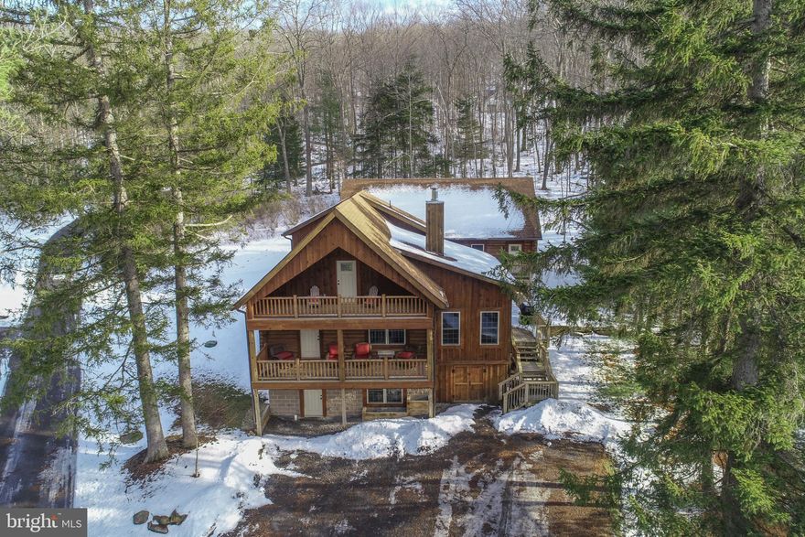 Nestled in a peaceful, private setting, this beautifully crafted 3-bedroom, 3-bathroom log home, built in 2019, blends rustic charm with modern comfort. This is an established vacation rental with numerous families returning every year! Thoughtfully designed for both relaxation and entertaining, the home features three expansive decks, offering abundant outdoor living space to enjoy the surrounding natural beauty year-round. Enjoy the enclosed sunroom during the summer or winter months! Unwind in the private hot tub, perfectly positioned for quiet evenings under the stars. Inside, the home showcases warm wood finishes, an open and inviting layout, and well-appointed living spaces that feel both cozy and refined. A standout feature of the property is the massive detached auxiliary building, complete with its own kitchen, bathroom and multiple gaming tables—ideal for guests, a bar setting, hobbies, entertaining, or potential additional use. Enjoy lake access, with the option to apply for a dock slip through the DNR (see the dock slip document in the documents tab), providing the opportunity to fully embrace the lake lifestyle. Whether you’re seeking a full-time residence, a mountain retreat, or an exceptional getaway property, this unique log home offers privacy, versatility, and access to everything that makes lake living special. Seller is also selling 76 Gravelly Run Road and is willing to consider and negotiate on an offer for both properties! Contact today for more information or to schedule a private tour!