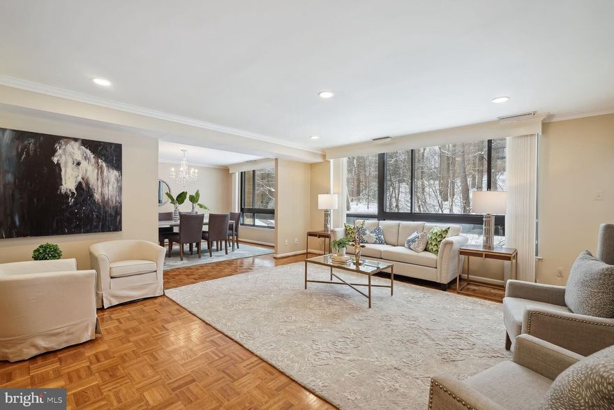 Offers, if any, due Tuesday, January 23 at noon.  Thank you!  Spacious and Serene One Floor Living in Sumner Village.

This is the condo you have been waiting for!  4986 Sentinel Drive #303 features 1,734 square feet of living space including a foyer, gracious formal living and dining rooms, a large open updated kitchen with beautiful counters and backsplash, two good size bedrooms and full bathrooms (including a spacious primary suite with sitting room, walk-in-closet and updated primary bathroom).  

A very special feature of this condo is that it has NO STEPS into the building, in the lobby or in the unit.  303 also features new windows in the living areas and a new full size washer and dryer.  The woodland views from the unit and balcony are lovely and private.  The condo conveys with two parking spots (separate tax ID) and a storage unit.  

This home offers easy access to downtown Bethesda, Washington, DC, and public transportation.  Additionally, it is steps away from the shops and restaurants of Sumner Place.