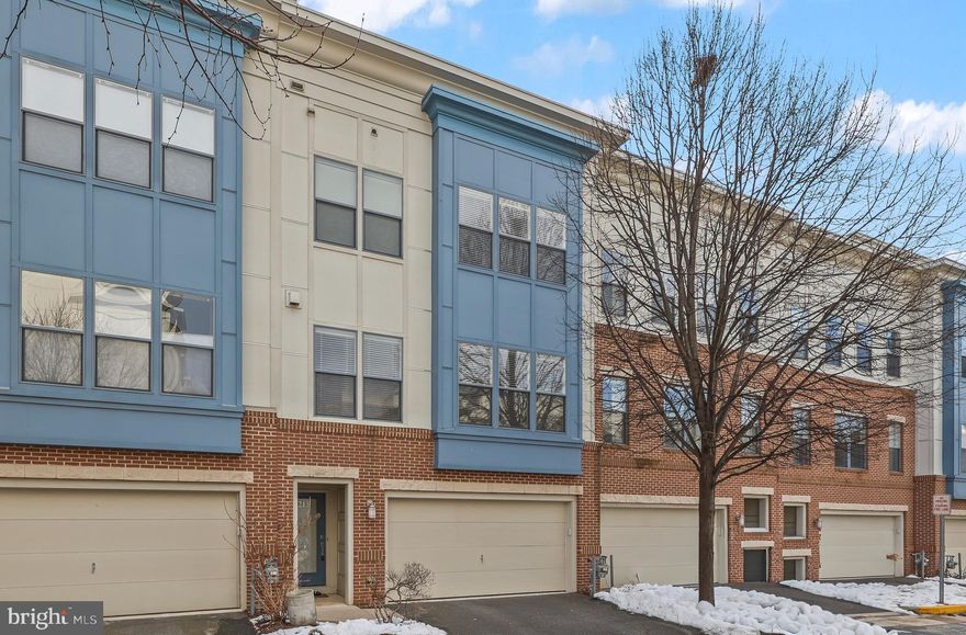 This four‑level townhome offers a bright, modern feel with the warmth of truly livable spaces, all just minutes from Fair Oaks Mall, Fair Lakes, Route 50, and I‑66. Meticulously maintained by the sellers, the home features three private outdoor spaces, including a lower‑level walk‑out patio, a kitchen balcony, and a top‑floor terrace. The entry level includes a bonus room/office with a closet, a coat closet, and a two‑car garage equipped with a 240V EV‑charging outlet and a Gladiator shelving system. Upstairs, the main level opens into a sun‑filled kitchen, dining, and living area with hardwood floors, a cozy fireplace, and CAT5 wiring. The upper level hosts an oversized primary suite with a custom walk‑in closet, a second bedroom with a hall bath, and a utility closet with full‑sized washer and dryer. The terrace level adds a third bedroom, full bath, sitting room, and a double‑sided gas fireplace framed by sliding doors to the outdoor terrace. With two HVAC systems, an OnQ whole‑home sound system, and a community offering three dog parks—including one right out front—this home blends comfort, convenience, and thoughtful upgrades throughout.