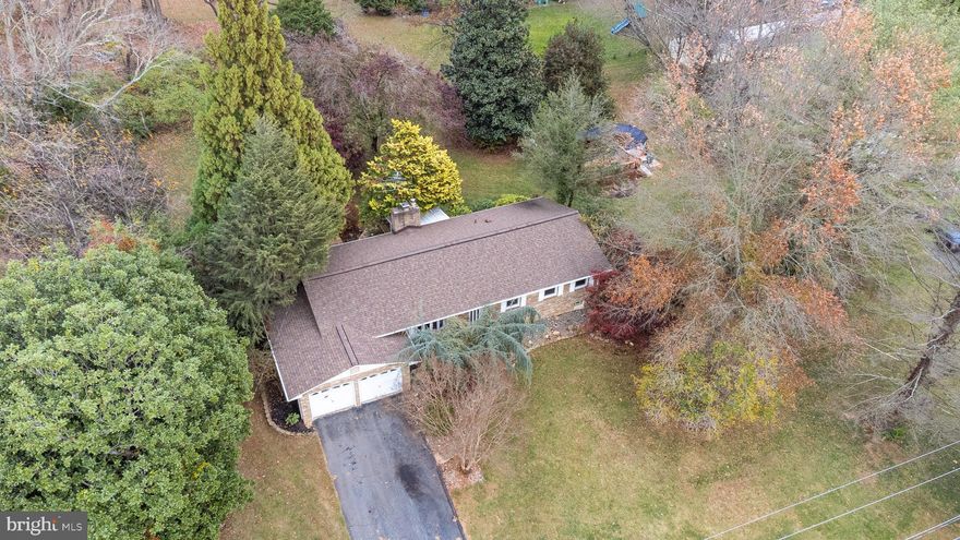 Welcome to this 3 bedroom, 2 full bath rancher with an attached garage on just under an acre of beautiful land.  Enjoy the mature landscaping throughout with producing fig bush and fruit trees, as well as ornamental exotic trees, fish pond, large cleared yard and above ground pool w/ pool deck.  Pool has an extra large filter, new pool deck and liner.  Inside the house find a fully renovated, high quality modern kitchen just done in 2024 with quartz counters and breakfast bar, backsplash, all new energy efficient stainless appliances and custom cabinetry such as roll out under counter drawers, spice racks and pantry.  Bonuses are under cabinet lighting, oversized steel sink, lazy susans and soft close.  The kitchen is open concept looking over a large dining and living room space with a wood burning fireplace and wood floors throughout.  A hallway off of the living room leads to a fully remodeled (in 2024) modern full bath with Quartz top vanity, low step tub/shower combo.  There are also three bedrooms, including an owners suite with a private modern full bath.  Off of the dining/living area are sliders that open out onto a 3 season sunroom that exits out onto the beautiful stone patio and walkway.  A door off of the kitchen leads out into the two car garage.  Stairs inside the garage lead down into a massive unfinished basement.  There is a new water condition and softening system.  The basement has been waterproofed has laundry facilities, and is ready for any of your creativity or just to hold unlimited storage.  This home is a true gem located in Fallston just moments away from Rt 1.