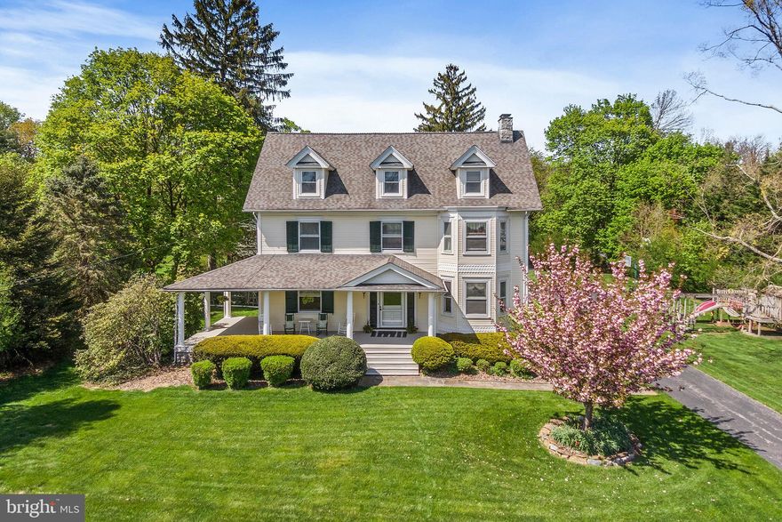 Step back in time as you pull up to 217 Highland Ave. in Devon, Easttown Township.  This luxury property sits off the road and is perfectly situated behind a white picket fence and long driveway.  Built in 1908 and lovingly maintained and updated this home is perfect for today's modern buyer looking for the elegance of yesteryear.  Modern amenities include natural gas heat, an 8-burner Blue Star Range/Oven for cooking, public water/sewer, a newer high efficiency central air system on all levels, a secluded fenced rear yard with pool and spa.   In addition, 217 Highland offers the convenience of a walkable lifestyle with easy access to the Devon train station, the famed Devon Horse Show, award winning T/E schools and newer shops and restaurants found at Devon Yards.    Another bonus is the incredibly low annual taxes.  
As you enter the home, step up to a spacious front wrap around porch with pillars and recessed lighting.  The front door is made of solid wood and sets the stage for this stately property.   The foyer is grand with high ceilings, incredible millwork and a main staircase with landings and gorgeous views out back.  Traditional pocket doors lead to all aspects of the first floor.   The Living and Dining rooms are open to create one large gathering area with a stone hearth and gas fireplace.  There are built-in window seating and gleaming hardwood flooring as well.   The parlor or den features recessed lighting, built-in bookshelves and opens to the large gourmet kitchen with granite countertops, updated solid wood cabinetry and rear staircase to second floor and access to rear entry mudroom and butler pantry.   Upstairs, find the primary bedroom with an adjacent office and spacious walk in closets.  The primary bathroom is spacious with double vanity and separate tub & shower.   There is another large bedroom on this level with a hall bathroom and a full size laundry room with 2nd floor clothesline system!  Up another level of living and find a very large 3rd bathroom with 3 more generously sized bedrooms -each one with fantastic sunny views.   The lower level is walk-out with daylight windows, water proofed and currently houses the exercise equipment, a workshop, a utility room and plenty of storage.  There is a detached two car garage with plenty of room for cars, bikes and storage.  The backyard is a private oasis with mature trees and perennials.  With only 3 owners in the last 118 years you can be the 4th and grab this Incredible Easttown Township showpiece.