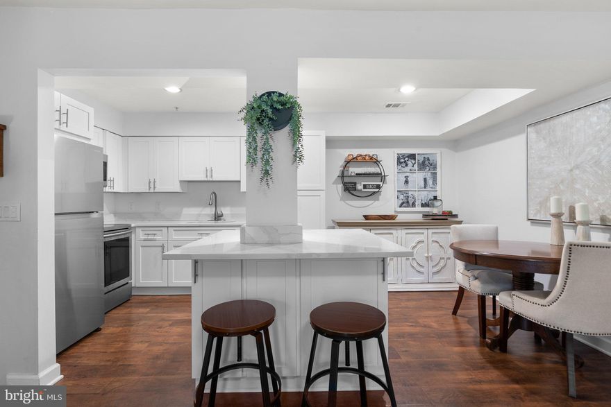 This absolutely immaculate Condo has almost everything replaced and upgraded with quality materials. Shows like a brand new Condo. New  HVAC, HW heater and windows .  Features include new flooring on all levels and on both sets of stairs, entry and bathroom, new railings, composite installed on balcony. The kitchen has been completely redesigned to add an island, recessed lighting, cabinets and drawers with additional pull out drawers inside pantry cabinets. The island includes plenty of storage space on either side. Newer appliances,  new ceiling fans, all new windows including frames and molding, new washer/dryer, 90 degree shut off valves , new light switches and electric sockets. The front door has been replaced along with all interior doors including frames along with a new slider on the bedroom closet door.  The Club House features a gym, party room, racquetball courts, and grills. The community includes pools, pickleball, and tennis courts. Walk to Grosvenor metro, Whole Foods, CVS, restaurants, Balduccis and an indoor pool. A very walkable dog friendly neighborhood near the Bethesda trolly track and Rock Creek Trail. Close to public transportation, 270 and 495. Offers due by 4 pm on October 29th