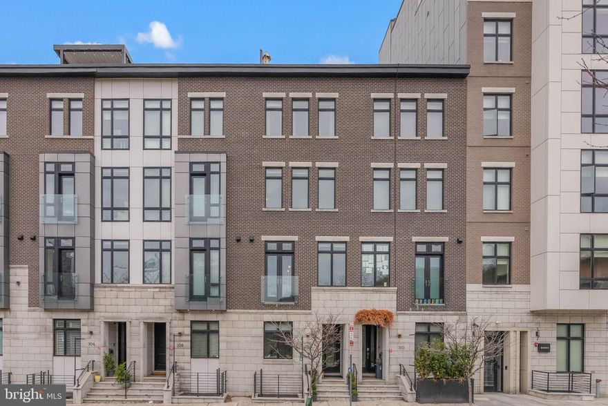 Commanding attention from the moment you step inside, 308 N 2nd St is a standout residence in the heart of historic Old City, where curated luxury, distinctive details, and exceptional livability come together across nearly 3800 square feet. This meticulously crafted home offers 4 bedrooms plus an optional 5th bedroom in the finished basement, 3 full bathrooms, 2 half bathrooms, a 2-car garage accessed from a secure driveway that provides additional parking, and multiple outdoor areas including an incredible roof deck. The exterior makes a bold first impression with a recessed entry framed by a towering masonry and brick façade. Inside, the first floor welcomes you with rich hardwood floors and a statement wrought iron staircase that immediately set the tone for the home’s elevated yet comfortable feel. The custom foyer features built-ins for added function, while a powder room, coat closet, and direct entry to the garage complete the level. Upstairs, the second floor opens to a dramatic living and dining space designed for effortless entertaining, highlighted by soaring ceilings, a wall of windows, and a floor-to-ceiling tiled fireplace that anchors the room. Sliding glass doors lead to a private terrace, creating a seamless indoor and outdoor connection. A wet bar adds convenience for hosting, and a discreet powder room sits just off the main space. A slight elevation change introduces the show-stopping chef’s kitchen, where bespoke cabinetry, waterfall quartzite counters, and a large island with seating are complemented by designer pendant lighting. Gaggenau stainless steel appliances, including a double range, built-in microwave and warming drawer, are paired with a farmhouse sink and tile backsplash to complete this beautifully finished space. The third floor is dedicated to a hotel-style primary suite and a generously sized rear bedroom that is ideal for a nursery or office. The primary bedroom is bright and spacious, featuring tall windows and dual walk-in closets. Its spa-like ensuite bathroom serves as a true retreat, adorned with a floating double vanity, heated floors, high-gloss cabinetry, striking tilework, a soaking tub, and a glass-enclosed multi-jet rainfall shower with a built-in bench. On the fourth level, you will find two additional bedrooms filled with natural light, including an oversized front bedroom featuring tall windows and a walk-in closet. The rear bedroom includes a walk-in closet, a private terrace, and a Jack-and-Jill connection to the full hall bathroom. A conveniently located laundry closet sits just off the stairs, and a wet bar is perfectly positioned to serve the roof deck above. The expansive roof deck offers an elevated outdoor experience complete with a fireplace and ample space for lounging or entertaining, all set against sweeping views of nearby Benjamin Franklin Bridge and seasonal fireworks displays. The finished basement adds even more versatility for a guest bedroom suite, den, gym, or playroom, plus a full bathroom. Additional highlights include hardwired speakers throughout, heated bathroom floors, multi-zone central A/C, gas heat, and gas hot water. Just beyond your front door, this prime Old City location delivers a Walk Score of 96! Friendly shops and top-rated restaurants like Radicchio Cafe and Tuna Bar are only a few blocks away. The nation’s history is on display nearby at Independence Mall, while lively waterfront events unfold along Penn's Landing, Cherry Street Pier, and Spruce Street Harbor Park. There is also easy access to public transit, I-676, I-95, and South Jersey. Schedule your tour today! HOA dues cover; alarm, fire system, snow removal, tree trimming, window washing, gate maintenance and insurance.