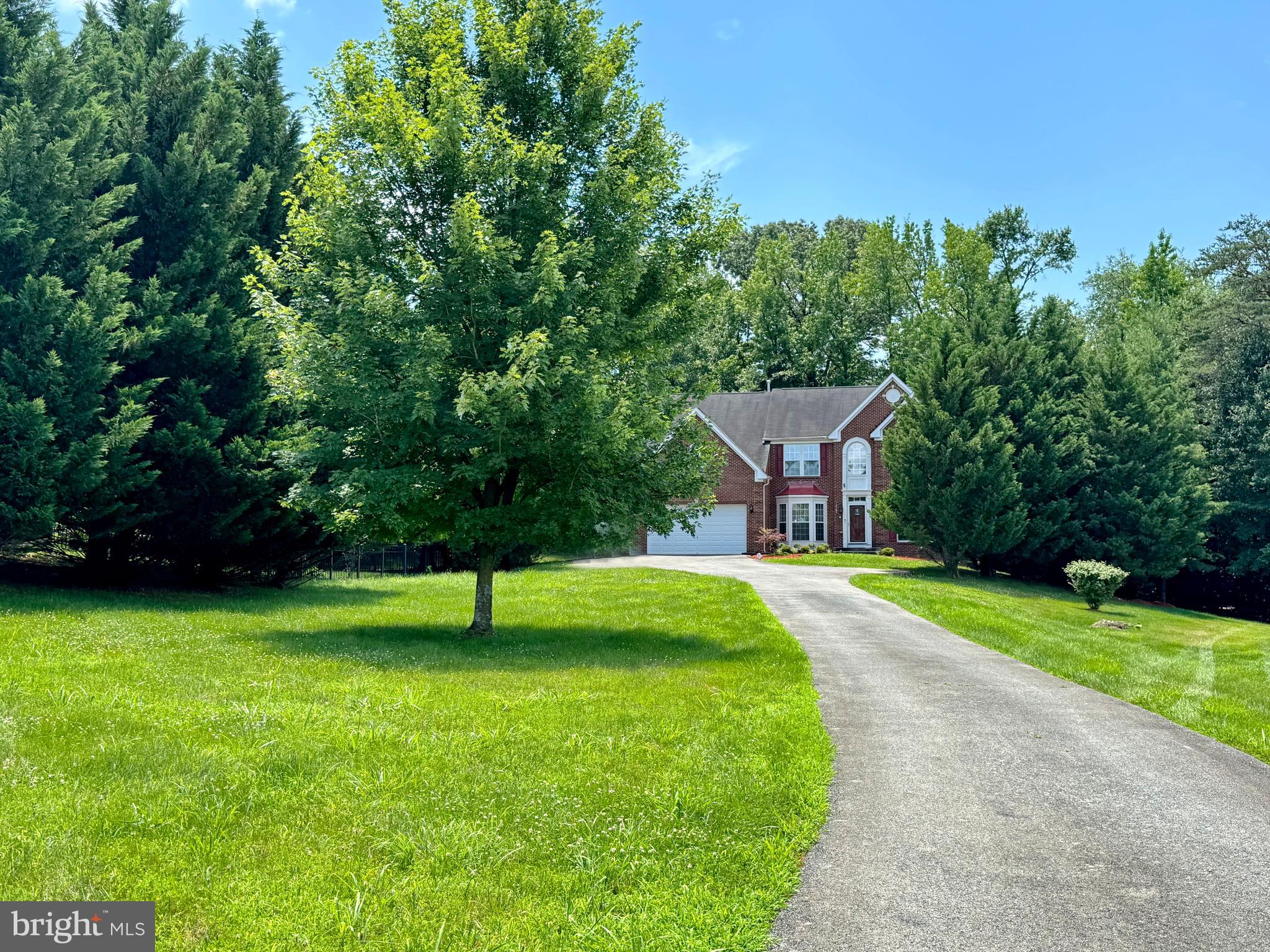 Beautiful large 2-story colonial is nestled back along the treeline on almost an acre. The paved driveway opens up by the house to allow for additional family and guest parking. The evergreen spruces offer year-round natural screening from the adjacent homes.
FOYER: The open foyer invites you in with natural hardwood floors throughout the main level except the kitchen area which is ceramic tile. FORMAL DINING: Is to the left of the foyer with bay window, tray ceiling, crown molding and chair rail. FORMAL LIVING : is to the right of the foyer with full floor to ceiling double windows. FAMILY ROOM : This open family room has a stately feel with columns and floor to ceiling windows. The fireplace makes it comfortable for easy conversation with family and guests. SUNROOM: Spacious and open with vaulted ceilings allowing for additional area for entertainment . KITCHEN:
Accented with cherry cabinets and quartz counter top and island. Large ceramic tile offers a nice separation between kitchen and family room. OFFICE: Good size office space or music room.
PRIMARY BEDROOM: spacious bedroom with 2 walk in closets. Owner's bath has ceramic tile, double separate sinks, jetted soaking tub with double windows above the tub allowing natural light. . Access to the second walk in closet through the bathroom has an arch window that brings in natural light.
3 OTHER BEDROOMS: Good size bedrooms upstairs. The 2 bedrooms facing the front have double windows. 2nd full bath in the hall. LAUNDRY: Separate walk-in laundry room with shelves and window.
STAIRS: Upstairs steps are hardwood with carpet cushion in center. BASEMENT: From the main level you have open access and attractive hardwood steps going to the basement. The basement has very large multi functional open area with casement windows and french doors to let in natural light. Good size storage and utility room, full bath with ceramic tile floor next to the theater room. Easy access to the outside with wide walk up steps and double french doors. Heating and AC replaced a year ago.
PLEASE NOTE: Seller may or may not be home and there is a small very friendly dog that may be in his cage or in the arms of the owners.