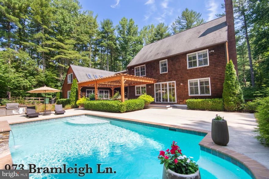 Discover this unique, architect-built   New England-style home on 2 acres, with cedar shingle siding and a sunny backyard featuring a heated saltwater pool. As you enter this inviting home, you will be greeted by abundant natural lighting from all of the architectural windows and warm hardwood floors throughout. The chef's kitchen boasts an oversized quartz island, ample cabinets, and large walk in pantry. Other distinctive features include 4 spacious bedrooms, a large his-and-her closet, a spa-inspired master bath w/ radiant heated floors and a finished studio basement space with separate workshop. Step outside to a peaceful oasis featuring the pool, built-in BBQ grill, large deck with Amish-built pergola, mature professional landscaping, and many established berries, fruits, and garden beds. Additional amenities include a large playroom above the two car garage (with potential for other uses), a home gym adjacent to the deck, and plenty of storage, enhancing the harmony of this space. This is a one-of-a-kind opportunity for a remarkable home on a private road in picturesque Annapolis. With its proximity to shopping area, downtown, schools and hiking trails, the location offers both convenience and tranquility.