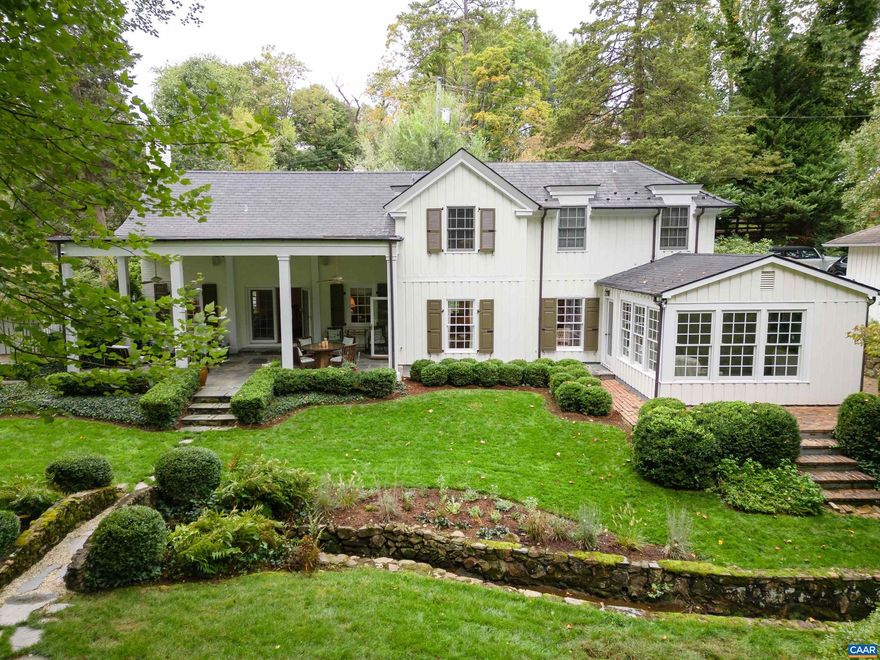 A truly rare offering, this immaculate storybook home on a private, double lot in the desirable Lewis Mountain neighborhood is an entertainer's dream. Originally built in 1910, with a Milton Grigg designed addition in 1935, this home has been meticulously maintained and brought forward for modern living. Enjoy almost a full acre of perfectly manicured grounds, designed and updated by landscape architect, Ian Robertson, with a stone lined brook winding through mature hardwoods and perennial beds and herb garden. The main house offers a unique floor plan with original floors and modern touches. The European inspired kitchen features marble counters, custom cabinets, and a stunning stainless and brass Italian oven. A main level addition features a light filled study with built in shelves and breathtaking views of the gardens. The covered back veranda provides the perfect space for entertaining or enjoying a quiet view of the gardens. A foot bridge takes you over the stream to a stone lined walkway and to the renovated 1 bed guest cottage with its vaulted ceilings, a new kitchenette, and an updated full bath. which sits on a separate lot with access from Rothery Rd. All this just steps from the University and minutes from downtown.,Cherry Cabinets,Marble Counter