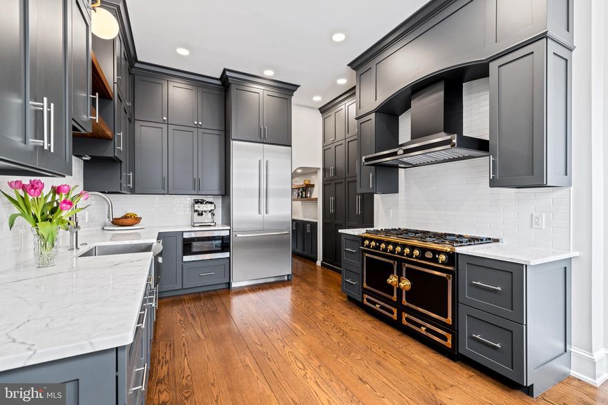 Welcome to this magnificent historic home on an extra deep lot nestled in the finest location that Society Hill has to offer. This home is brimming with history while also including all of the modern conveniences you could ask for and more. Blending designer finishes, historic richness, soaring ceilings, and unrivaled outdoor space, this elegant light-filled home captures the essence of luxury urban living. Offering approximately 4,100 square feet of beautifully curated living areas, this breathtaking move-in ready residence provides a wonderful footprint for busy daily life and elegant entertaining with five levels of expanded living space, luxurious beds and baths, and a charming brick patio with an expansive back garden.
 
Enter this stunning home through the elegant light-filled foyer featuring marble tile and original transom window. Proceeding forward, you are drawn down the grand hallway leading you past the dramatic sweeping staircase and into a breathtaking living room and dining space featuring original marble fireplace, 13’ ceilings with restored plaster moldings, and original large paned casement windows looking out onto the brick patio and lush garden. 
 
Just off the living room, pass through a light filled portico to enter the landscaped brick patio and expansive garden perfect for morning coffee or evening cocktails. This stunning outdoor oasis with mature trees and shrubbery set in the heart of historic Philadelphia mere steps away from world class dining, boutique shops, and national historical monuments is truly one of a kind. Framed by a regal magnolia tree, brick walls, and new 6’ tall cedar fence slightly offset from the surveyed property line, you will enjoy unrivaled privacy and tranquility amidst all of the excitement and cultural opportunities America’s first capital city has to offer. 
 
From the front vestibule to your right, enter the gourmet chef’s kitchen with breakfast nook that fulfills every cook’s dream. This designer kitchen features a handcrafted La Cornue CornuFé 110 range and hood along with luxury Thermador stainless steel appliances, beautiful floor to ceiling custom wood cabinetry, marble countertops, and designer lighting. Connecting the designer kitchen to the living room and dining space is an extended wet bar featuring custom wood cabinetry, floating shelves, and bar sink, perfect for entertaining.
 
On the lower level, the finished basement includes an oversized family room featuring original fireplace with built-in cabinetry perfect as a playroom, media room, home gym, au pair suite, or all of the above. The finished basement also includes a marble tiled powder room, exceptional storage, second laundry room, and another large multi-purpose room with walk-out access to the back garden.
 
Moving upstairs, the second floor includes a library/family room in the front of the home featuring custom bookshelves, restored plaster moldings, and original large paned casement windows. Adding to this room’s charm is an impressive wood-burning fireplace with spectacular marble mantle and surround.  Presently furnished as a bedroom, this room is the perfect place to enjoy a cocktail or read a book by the fire on cold winter nights. The main bedroom suite is also located on this level with ample closet space and updated bathroom fixtures. The third level includes two spacious bedrooms complete with original large pane casement windows with interior shutters and designer lighting, in addition to a full bath with laundry area. The fourth floor features two more bedrooms, perfect for serving as guest rooms and/or a home office or music room.
 
From top to bottom, this stunning home represents an elegant blend of historical charm and modern luxury. A short walk away are Headhouse Market, which has craft and farmers’ markets on weekends, and Penn’s Landing, offering spectacular river views. Seller will give a credit towards parking for one year from purchase in nearby lot or garage.