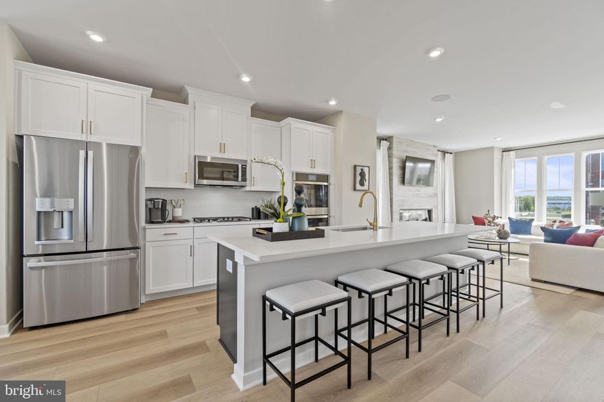 Brand new Stanley Martin townhome in Sterling, Virginia in Arcola Town Center! This beautiful 2-car garage townhome boasts a modern open floorplan that is great for entertaining. You'll find an impressive and functional gourmet kitchen with an oversized island that offers plenty of room for the home chef and food enthusiast alike. The adjacent family room and eating area offer the perfect space for gathering with loved ones. After the fun, retreat to your primary suite with a private ensuite bath and spacious closet. This room may become your favorite, and will certainly inspire you to put your feet up and relax. Down the hall, two additional bedrooms with a full bathroom offer comfortable options for family and friends. Downstairs, the lower level features a bedroom and full bath, the perfect spot to host guests or transform to a second family room, home gym, or a private home office. Picture morning coffee and yoga before the day is underway on your massive kitchen-level deck. Photos shown are from a similar home. Schedule a tour or stop by and visit our model home today! 

Outside your doorstep, you'll find a tot lot and neighborhood pool with a clubhouse. Directly adjacent to the neighborhood is the newly opened Elaine Thompson Elementary School. Everyday conveniences are just around the corner at Dulles Landing with Walmart, Dicks Sporting Goods, Bed, Bath & Beyond and more. Additionally, there are many recreation options nearby with the new Hal and Bernie Hansen Regional Park and Dulles South Recreation Center just a short drive away. Whether you're looking to upsize, downsize or purchase your first home, you will find a home that fits your lifestyle at Arcola Town Center. Visit us today!