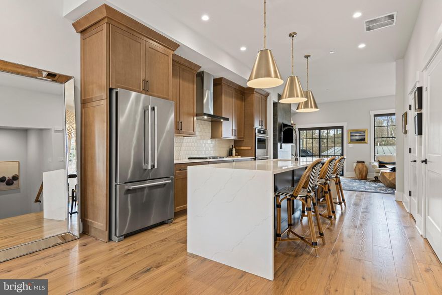 206 N Aberdeen Ave, Unit C offers a greatly sought-after "Walk-to-Wayne" lifestyle in an exceptional, nearly-new luxury resale at Rockwell on Aberdeen. Built in 2022 by Rockwell Custom Home Builders, this exclusive 6-townhome enclave provides the pinnacle of low-maintenance living in the heart of Radnor Township. Unit C distinguishes itself with high-end custom finishes across four finished levels, featuring the added convenience of a private 3-stop elevator serving the lower level, main floor, and primary suite level.
The main level welcomes you with an airy, open-concept floor plan featuring rich solid wood floors, 10-foot ceilings, and beautiful solid wood interior doors throughout. The sun-drenched dining area, anchored by a gorgeous statement chandelier, flows seamlessly into the gourmet kitchen. A true showstopper, the kitchen features an extra-large waterfall quartz island with a deep undermount sink, handsome wood cabinetry, gorgeous tile backsplash and a premium JennAir stainless steel appliance package including a double wall oven. Beautiful designer pendant lighting and recessed lighting illuminate the space, which leads into a spacious Great Room centered around a sleek natural gas fireplace with floating wood shelves on either side. Through black-framed sliding doors, enjoy a private composite deck with privacy walls—an ideal retreat for morning coffee or evening relaxation.
The second floor serves as a dedicated sanctuary accessible by both stairs and elevator. The luxurious Primary Suite is outfitted with hardwood floors, elegant crown molding, and two walk-in closets with custom shelving. Its spa-like ensuite bath offers dual vanities and a large glass-enclosed shower with a dual-head system. Also on this level is a spacious second bedroom with its own hall bath featuring a bathtub, and a conveniently located laundry area.
Continuing upstairs, the third-floor loft provides incredible versatility as a third bedroom, home office, or media room, complete with its own full bathroom and bonus living space.
The finished lower level (also served by the elevator) is outfitted with durable luxury vinyl flooring and provides a highly functional layout including a private home office, a bonus room space, and a powder room. This level also provides direct access to the attached rear-entry garage. Modern systems include 4-zone natural gas HVAC for precision comfort on every floor.
Located in the top-ranked Radnor Township School District, this property is just 0.5 miles from the Wayne Train Station, providing direct service to Philadelphia and NYC via Amtrak. Commuting is made easy as Route 30 provides quick access to I-476, with major corporate centers nearby in Radnor. Conveniently located in Wayne, you are minutes from iconic local dining like Rosalie, The Goat’s Beard, and Christopher’s, as well as popular shops including Best Hardware, Gingy’s, and Ballard Designs. This central location is perfectly situated close to neighboring Main Line towns including Villanova, Bryn Mawr, and Berwyn. From the nearby Strafford Farmers Market to the scenic Radnor Trail and the luxury shopping at King of Prussia, everything is within reach. Don't miss this rare opportunity for modern luxury in the heart of the Main Line.