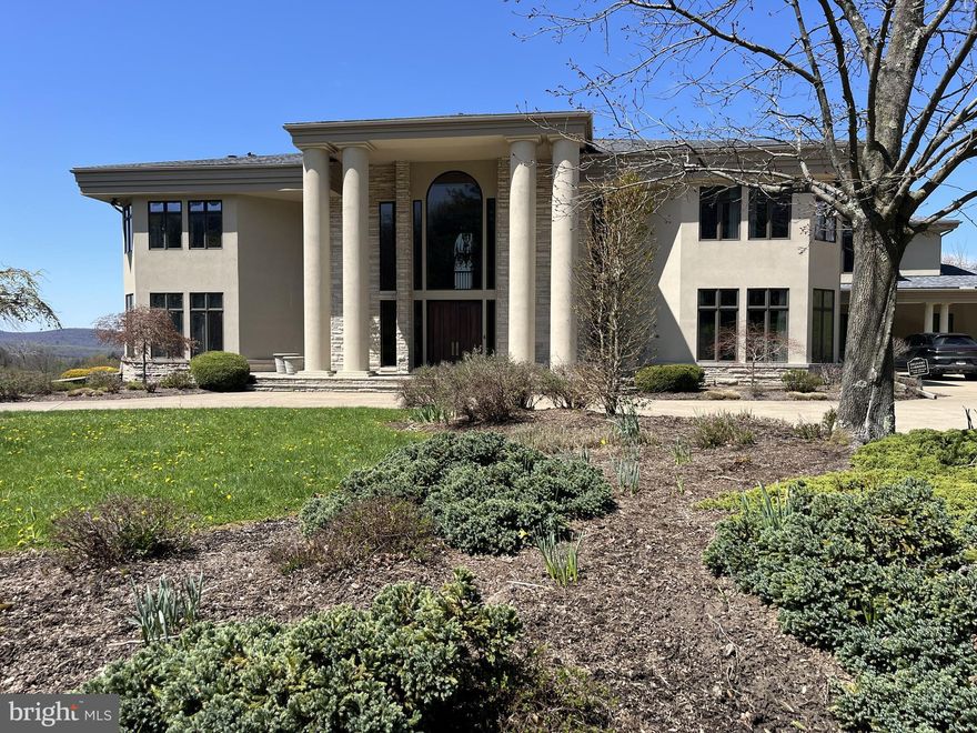 Experience luxury at its finest in this extraordinary contemporary estate nestled in Waverly Township. Offering 24.38 acres and over 10,000 sqft of living space with five bedrooms, five full baths, and two half baths, this residence seamlessly blends sophistication, comfort, and exceptional amenities. The property provides convenient access to Abington Heights School District, shops, dining, country clubs, outdoor recreation in Clarks Summit, and Lackawanna State Park. Approximately 7 miles from Scranton preparatory, 20 miles from Wyoming Seminary, 65 miles from Blair Academy in Blairstown NJ, also nearby University of Scranton, Commonwealth Medical School, Penn State University, 11 miles from Montage Mountain featuring concerts, skiing, water park, and shopping, 16 miles from Elk Mountain Ski Resort, 30 minutes from the Pocono Mountains, and only two hours from both NYC and Philadelphia.

A tree-lined entrance welcomes you to the circular driveway, breathtaking mountain views create a stunning first impression. Designed for relaxation and entertaining, the outdoor living spaces are exceptional, an inground saltwater pool with HydraPure filtration system and electric safety pool cover, expansive patios, a pool/sitting room with bath, inviting back porch, fire pit, and landscaped grounds that create a private retreat ideal for hosting guests. Additional highlights include three gas fireplaces, a elevator with access to the main and second levels, and two separate staircases to the upper floor.

Inside, the dramatic two-story marble foyer features recessed lighting, chandelier, and a magnificent bifurcated staircase. Flowing seamlessly from the foyer, the formal dining room showcases hardwood floors, crown molding, wainscoting, and elegant lighting, the adjacent butler’s pantry offers built-in cabinetry, recessed lighting, hardwood flooring, and access to a second walk in pantry.

The chef’s kitchen is thoughtfully appointed with hardwood floors, two oversized islands, commercial-grade hood vent, wet bar with overhead lighting, double ovens, two warming drawers, separate Sub-Zero refrigerator and Sub-Zero freezer, and a premium six-burner range with optional wok station, cast iron grill, and griddle. Just beyond, the breakfast area overlooks the patio and pool, while the adjoining great room impresses with hardwood floors, coffered ceiling, crown molding, and a striking 29 feet limestone gas fireplace, along with direct patio access for seamless indoor-outdoor living.

The main level also features a spacious media room with built-in cabinetry, speakers, carpeting, and French doors leading outside; an elegant front living room with hardwood flooring and gas fireplace; a private office/study featuring custom mahogany paneling and floor-to-ceiling built-in shelving; two half baths; spacious laundry room; and a full bath with a steam shower.

Upstairs, the luxurious primary suite serves as a private sanctuary featuring recessed lighting, gas fireplace, sitting area, and two expansive walk-in closets with custom built-ins. One closet includes additional flex space ideal for a hobby room or fitness area. The spa-inspired primary bath offers an oversize jetted tub, steam shower, and water closet. Four additional generously sized bedrooms, convenient walk in cedar closet, two full baths, and an additional laundry room finish the upper level.

The expansive lower level offers approximately 5,000 square feet of additional space with vinyl flooring and endless possibilities for recreation and entertainment, along with an additional full bath.

Completing the property is a heated 4-car garage with Tesla car charger and parking accommodations for up to 10 vehicles in the expansive driveway. This exceptional Waverly Township estate masterfully combines timeless elegance, luxurious amenities, and extraordinary living spaces into one unforgettable property. Schedule your private tour today.