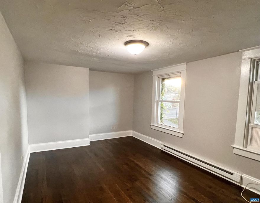 Do not miss this renovated charming 2nd floor apartment in this 1930's Triplex property. Available for 6 month to 1 year lease. BRAND NEW KITCHEN, NEW BATH, New vinyl floors in kitchen, bath and Laundry/eating area. There are newly refinished Hardwood floors and we just upgraded a new electric panel, installed a full-size washer dryer hook up and are providing a washer, dryer, New Electric heat and a new roof was just installed. You won't find one this nice in the downtown area at this price! Use the rooms as you like, there is a small laundry room/eating area, that could also serve as a nursery or home office. The large Living room, could be your bedroom, the smaller bedroom, could be the Den. You decide! This place looks awesome!