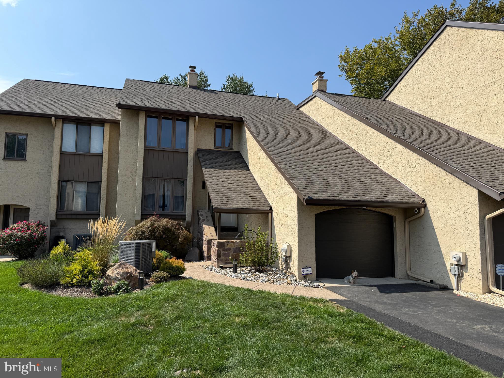 Welcome to Windybush, one of the most desirable communities in Langhorne, known for its well-kept homes, vibrant landscaping, and sidewalks on both sides of the street. Step inside home #42 and experience the quality craftsmanship and thoughtful details throughout. Beautiful hardwood floors and Venetian plaster walls greet you at the entry and continue throughout the home. A coat closet is conveniently located near the entrance, and to the left is a cozy room with a fireplace.
The main level offers a spacious living room and dining area, seamlessly connected to a fully renovated kitchen with quartz countertops. The living room opens through sliding glass doors to a generous balcony—ideal for grilling or outdoor dining just steps from the kitchen.
Midway up the staircase, you’ll find a large bonus room thoughtfully designed as a home office. On the upper level, the hallway leads to three bedrooms. The first bedroom overlooks the front of the home with a lovely view, while the second is exceptionally spacious and features a large closet. Across the hall is the primary suite with a walk-in closet and private full bath. A second full bath in the hallway serves the additional bedrooms. The laundry area is also conveniently located on this level.
The lower level offers incredible versatility. Directly off the stairs is a bonus room that can serve as a guest bedroom, while the remainder of the basement is open and filled with natural light from windows and sliding glass doors. This walk-out level leads to a private patio, thoughtfully divided into two sections—perfect for a sitting area and a dining area for entertaining. The fenced backyard enhances privacy and faces the interior of the community, with beautiful green space maintained by the association.
This home offers an ideal combination of comfort, style, and location. With easy access to major highways, shopping, and restaurants, while still providing a peaceful setting away from noise, it is a true must-see. Don’t miss this opportunity!