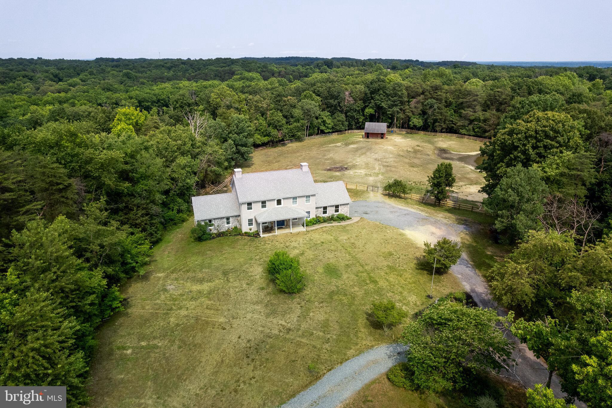 Amazing farmette in Elk Neck on over 9 acres ready for you to bring your horses. Long private driveway leads to this beautiful, move in ready 5 bedroom, 2.5 home. Main level offers a first floor owners suite with hardwood flooring, vaulted ceilings, updated bath with custom tile shower with glass door and dual vanity, new kitchen with LVP flooring, white cabinets, granite counters, new appliances including glass cooktop with pot filler and pantry with slide out drawers, separate family room and dining room and family room with gas fireplace and built in shelving.. Mud/laundry room leads to two car garage. The large two-tiered deck offers amazing views of pastures and pond and offers great entertaining space. The upper level offers four spacious bedrooms and updated hall bath. Partially finished basement with bonus room that offers a window and door with direct access to rear yard. Approx 3+ acre paddock with new fencing plus, three stall barn with feed and tractor room, hayloft and chicken coop. Barn offers water and electric. Additional building offers great storage space for tools and equipment. Other features include hardwood floors, custom trim and molding. One-year warranty included. Property next to this home will also be available for sale soon and is owned by same family.