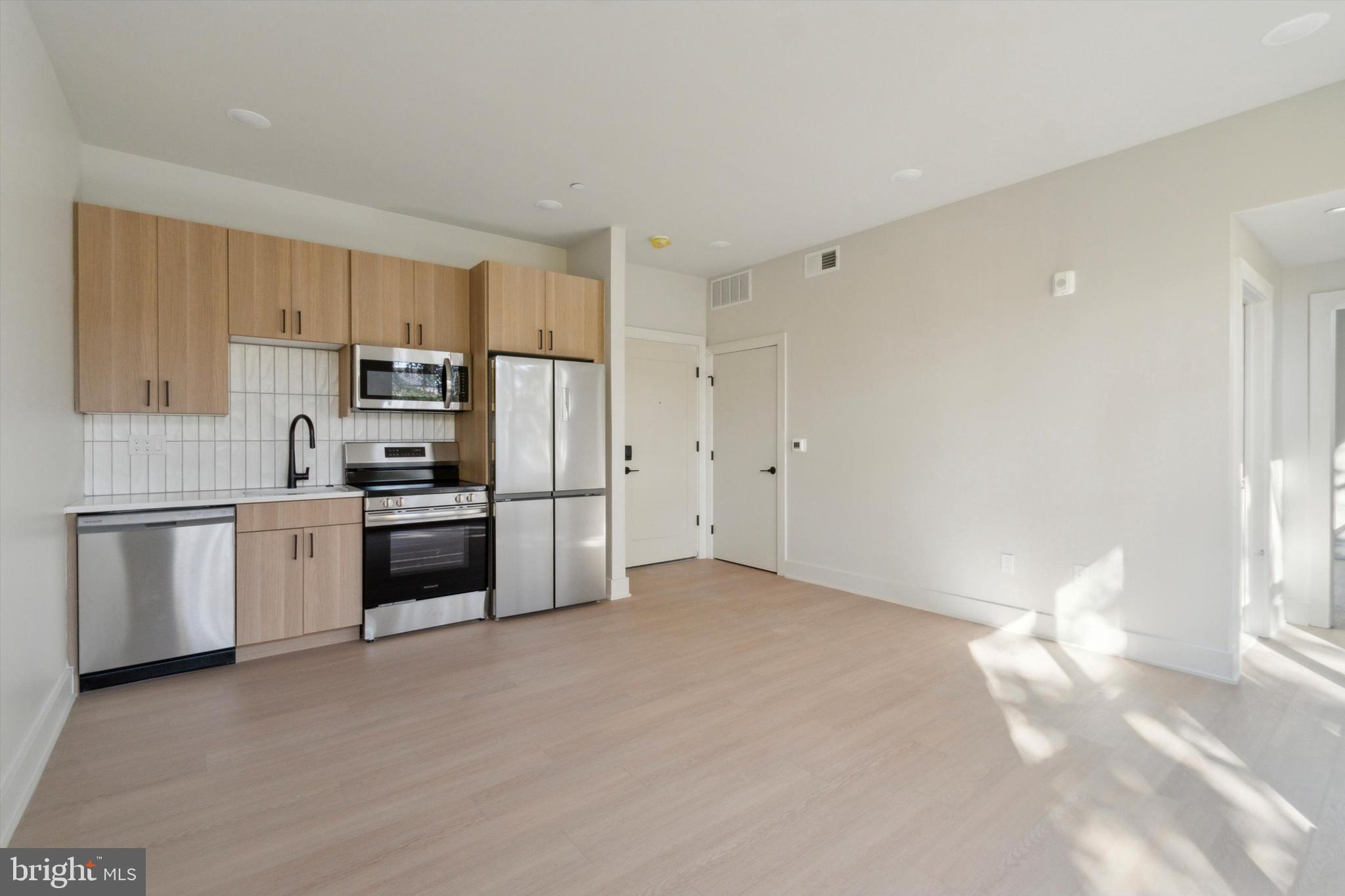 Welcome to The Grove: Modern Living in Germantown, Philadelphia. Experience luxury at The Grove, a six-story, 50-unit community at 5521 Wayne Avenue. Located near Chelten Ave SEPTA Station, Germantown Ave, and I-76, it offers easy access to Center City and local amenities, including grocery stores and the scenic Wissahickon Valley Park. Enjoy premium amenities like a fitness center, rooftop deck, resident lounge and much more at The Grove! Unit 607 offers a beautifully designed galley kitchen that flows seamlessly into a spacious open-concept living area, perfect for relaxing or entertaining. The large bedroom features a walk-in closet, providing plenty of storage space!.