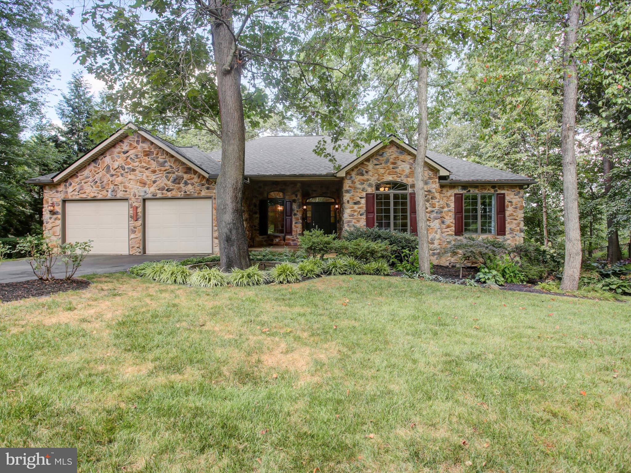Welcome to 2628 Castlegreen Drive, located in the desirable Greencastle Greens community just steps from the golf course. This spacious home offers 4 bedrooms and 3 full baths, including a main floor primary suite with a private bath. The main level also features a wood-burning fireplace, fresh paint, new flooring, and abundant natural light. The fully finished walkout basement provides additional living space with a family room, bedroom, recently remodeled full bath, new flooring, and a workshop area. Set on over an acre backing to trees and the Conococheague Creek, the backyard offers a peaceful setting with plenty of wildlife to enjoy. Outdoor highlights include professional landscaping, an underground irrigation system, and a deck overlooking the wooded lot. Recent updates add peace of mind with a new roof (2025) and new HVAC system (2023). This beautifully maintained property combines comfort, convenience, and a scenic setting—ready to welcome its next owner.
