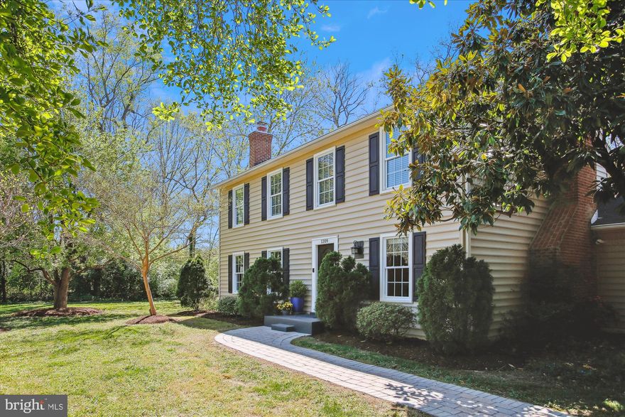 Saturday Open House, 04/27 from 2:00-4:00pm. Welcome to this charming home nestled on a tranquil 1/2 acre lot where blooming crepe myrtles and fig trees enhance the picturesque landscape. This 4 bedroom, 2.5 bath house offers a perfect blend of elegance, comfort, and natural beauty.

Upon entering, you'll be captivated by the classic layout and exquisite details throughout. Gorgeous hardwood floors exude warmth, guiding you through the inviting spaces. To the left, French doors open to a formal living room adorned with beautiful moldings and a wood-burning fireplace, ideal for cozy gatherings. On the right, a more casual gathering space awaits, featuring a second wood-burning fireplace with an all-brick surround, perfect for relaxed evenings with loved ones.

The heart of the home lies in the gourmet kitchen, boasting stainless steel appliances, granite countertops, and a breakfast bar that beckons you to gather and create memorable meals. Adjacent is a separate dining room, providing an elegant setting for formal dinners and special occasions. Glass sliding doors seamlessly connect the indoor and outdoor spaces, leading to the stunning backyard patio, an idyllic place to gather with friends for a barbecue or simply enjoying peaceful evenings in the tranquil setting.

Completing the main level is a home office, offering a quiet retreat for remote work, and a convenient half bath for guests.

Upstairs, you'll discover four bedrooms with tranquil views from every window. The primary en-suite bedroom is a luxurious retreat, featuring a spacious bathroom and a walk-in closet, providing ample storage. A full bath services the other bedrooms and a pull-down attic offers additional storage space for your convenience.

Outside, an attached two-car garage and a horseshoe driveway provide easy access and ample parking for you and your guests, ensuring convenience and comfort.

Nestled adjacent to Collingwood Park, this home enjoys a prime location just one block from the GW bike path and GW Parkway. With this convenient positioning, residents have effortless access to Old Town, DC, Belvoir, the Pentagon, and Reagan National Airport.