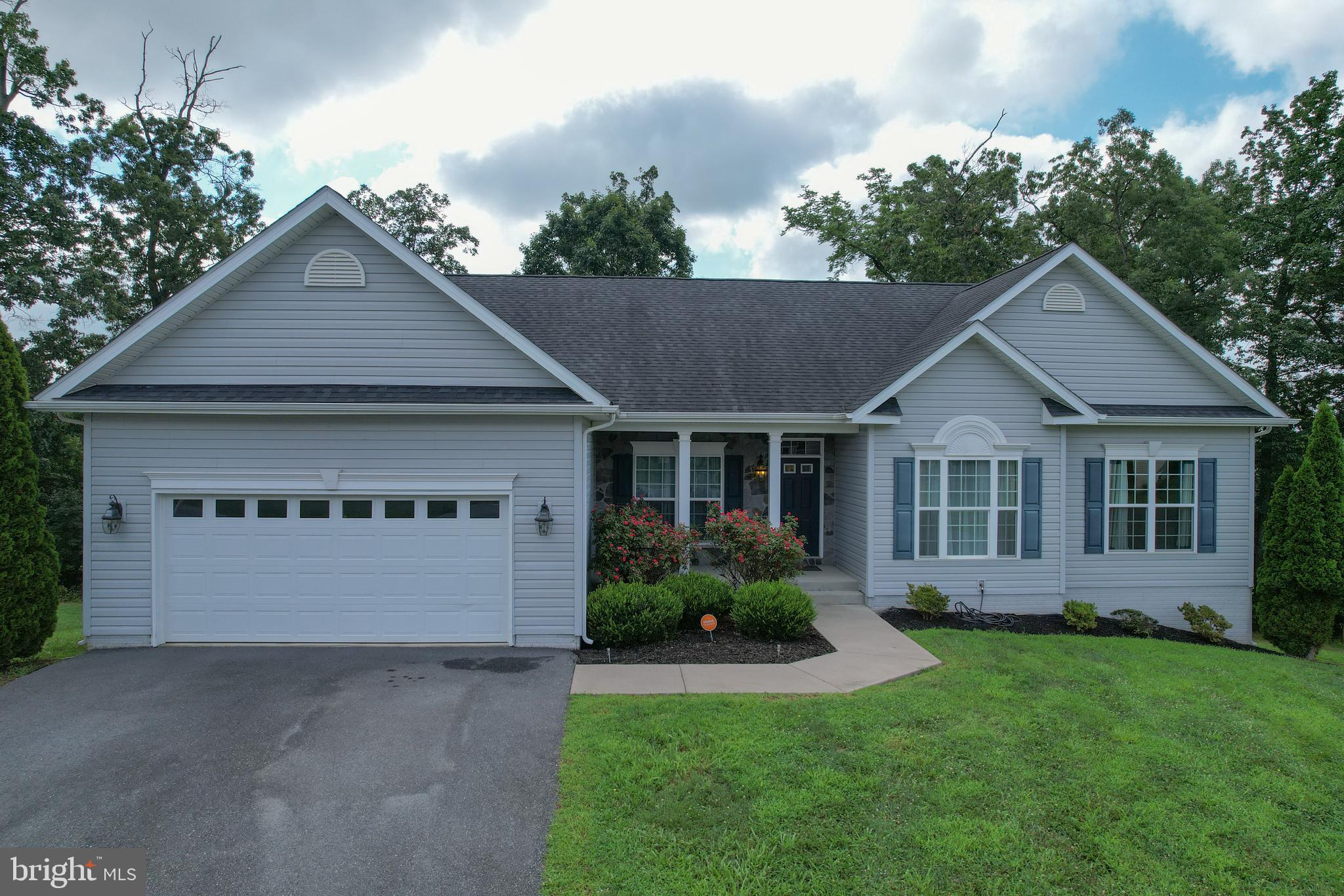 Showings begin August 7! The inside is as beautiful as the outside! Booking appointments now!
Step into this beautifully maintained, one-owner ranch home offering over 3,000 finished square feet of versatile living space in a peaceful cul-de-sac setting. With 3 bedrooms and 2.5 baths on the main level, plus a fully finished lower level featuring an efficiency kitchen, full bath, and multiple flex rooms—this home is ideal for multi-generational living, guests, or your next big project.
The main level boasts an open-concept layout with gleaming hardwood floors throughout the foyer, living, and dining areas. You'll love the spacious eat-in kitchen, complete with bar seating and generous table space, perfect for casual meals or entertaining. The living room flows seamlessly into a formal area that can serve as an office, or game space set apart with classic clear-paned french doors. Use the classic dining in the main entry to suit your lifestyle needs.
The primary suite is a true retreat with a large walk-in closet and a luxurious tiled shower enclosed in glass. The main level bedroom includes a reading or dressing nook for additional space. Located on the other side of the house, two additional main-level bedrooms are generously sized with ample closets and storage. The hall bathroom is bright and ready for guests with a tub/shower combo.
A large laundry room is on the main level with access out to the 2-car garage. The energy efficient appliances including the washer and dryer convey with the home. This house is turnkey and ready for your enjoyment!
Outside, unwind on your expansive wooden deck, nestled among mature trees—ideal for morning coffee or evening gatherings. Enjoy the quiet privacy of cul-de-sac living while still being close to everyday conveniences. The neighborhood, Brookfield on the Potomac, is well established and sought after for its incredible amenities like a boat ramp for deep water Potomac River access, walking path, play fields, basketball courts, river views and a private pavilion for homeowner's and their guests. Welcome Home to West Virginia, you are going to love it here!