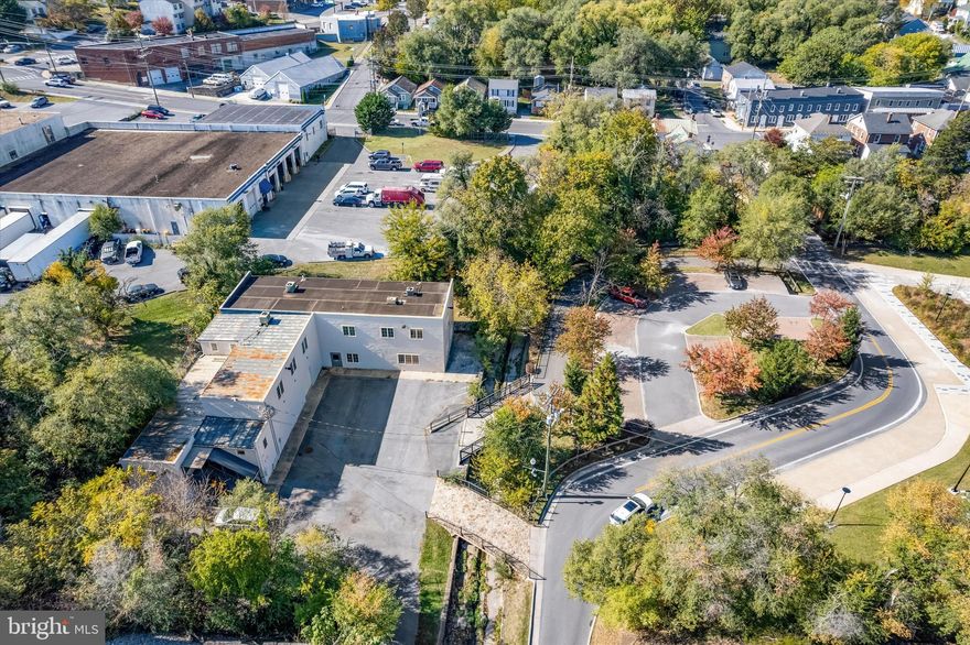 14K SF Warehouse and Office Building for Sale, Winchester City, with Great Parking! Excellent, turn key condition property, ready for immediate occupancy! All block and masonry building, fully air conditioned (including warehouse), all mechanicals, electric, and plumbing in good condition! 1st floor consists of 5K SF of warehouse, 2K SF of finished open offices with kitchenette. 2nd floor is 7K of individual offices, reception area, and 2nd kitchenette. Warehouse, 1st floor offices, and 2nd floor offices, all have separate restrooms (ADA on 1st floor). Property comes with two private parking lots offering over 30+ parking spaces!  Although the property has never flooded, financing may require flood insurance. We have already secured an excellent quote for only $3,395 per year. This is an EXCELLECT DEAL for under $72 PSF! CM1 zoning allows for contractors offices, church, daycare, fitness facility, wholesale business, light manufacturing/warehousing. One tenant occupies small, secured portion of building through 2026 offering $1275+/month income. Contact Agent today to schedule a showing!