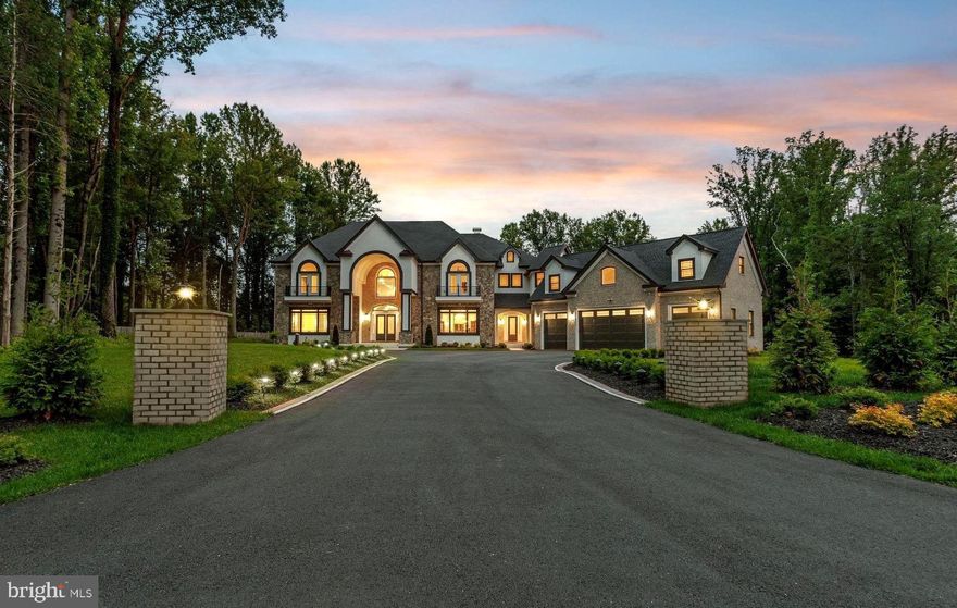 Luxury, space, and unmatched craftsmanship come together in this spectacular Great Falls estate. Set on nearly 3 acres and just minutes from Great Falls Village Centre, this residence offers the perfect blend of privacy, prestige, and comfort. Step inside and be instantly impressed by soaring 24-foot ceilings in the foyer, flanked by a sweeping dual staircase. Designed for both grand entertaining and relaxed living, the main level features a stunning 2-story great room, formal living and dining areas, a home office with custom built-ins which can double as a main level bedroom, and a covered patio with a full outdoor kitchen. At the heart of the home is a chef’s dream kitchen with Wolf Sub-Zero appliances, an oversized 14 ft. island, and top-tier finishes. The upper level is anchored by a luxurious owner’s suite with a private balcony, two walk-in closets, and a spa-style bath. Three additional ensuite bedrooms each feature walk-in closets, Juliet balconies, and their own private baths. A separate suite above the garage includes its own living space and full bath, perfect for guests, in-laws, or a caregiver. The fully finished lower level has it all: a home theater, wine cellar, exercise room, sauna, wet bar, and open recreation space with 9' ceilings. Additional highlights include hardwood floors, detailed crown molding, Anderson windows, granite and quartz countertops, an enterprise-grade security system, whole-house WiFi, a sealed 4-car garage, and no HOA. Conveniently located just minutes from Tysons Corner, top-rated dining, scenic parks and trails, Great Falls Village Centre, and premier golf at River Bend Country Club and Trump National Golf Club. Enjoy easy access to Route 7, I-495, the GW Parkway, and Dulles Airport, offering exceptional location, lifestyle, and luxury all in one. Don’t miss the opportunity to own one of Great Falls' most exceptional properties.
