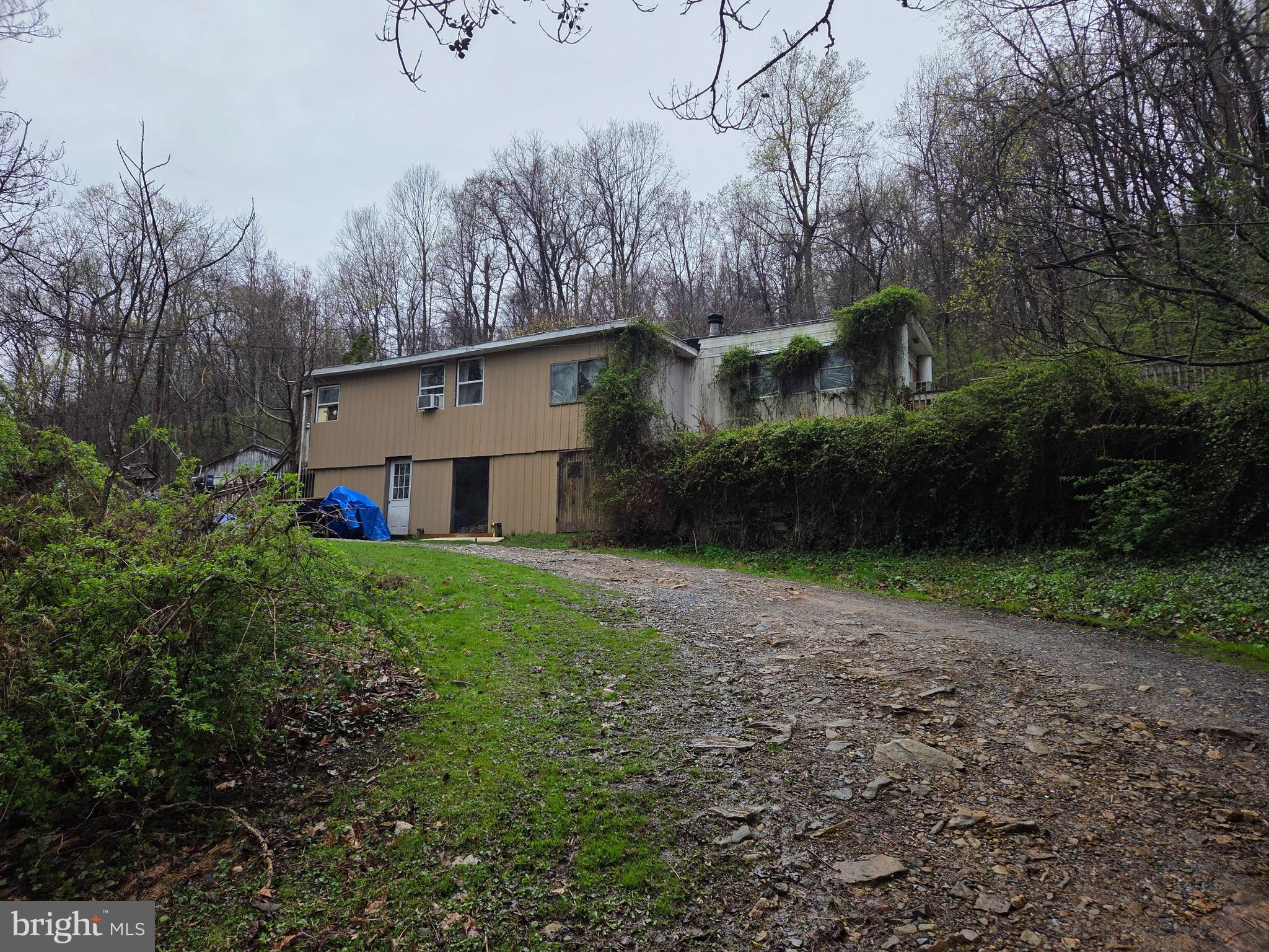 Discover over 6 beautiful acres (+/-) on 1216 Roberts Valley Rd, Harrisburg — This property offers a unique combination of privacy, natural beauty, and practicality. The land is equipped with a good well and good septic system, providing a strong foundation for future building plans. A 12x60 mobile home and a 2-car block garage with 12-foot ceilings are included, but the true value lies in the land. The existing structures are in poor condition and are being sold as is. Enjoy the abundant wildlife — deer, turkey, and other game are frequent visitors — and the serene, wooded surroundings. With easy access to nature yet close to amenities, this is an excellent building lot for your dream home, retreat, or investment. Don't miss this rare chance to own a prime piece of Roberts Valley!