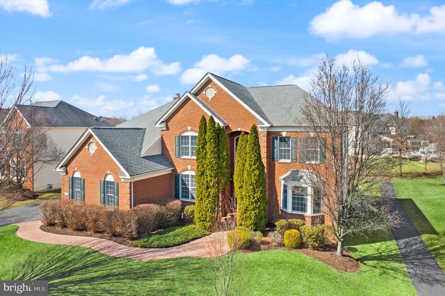 Welcome to the prestigious Belmont Country Club community and this meticulously maintained, brick front, Estate Series Somerset model home nestled within an award-winning 18-hole Arnold Palmer Signature golf course. As you enter the home, you are greeted with a rounded double height foyer showcasing a curved staircase and recently refinished solid hardwood floors. A private office, formal living room, and formal dining room are directly off the foyer and the recently refinished hardwood floors showcase the elegance of the home. Additionally, with a spacious kitchen, informal dining, large open family room, and a powder room, the main level is perfect for entertaining. With french doors off the sunroom that lead to covered porch and an additional open air deck with stairs to the backyard, the outdoor living spaces create endless possibilities for relaxation and hosting, to compliment any lifestyle. Access to the recently epoxy coated 3-car garage through a spacious tiled mudroom with laundry.
On the upper level, the primary suite features a large en-suite with double vanities and double closets with custom organization. The additional upstairs bedrooms feature a junior suite with en-suite bathroom and two rooms sharing a jack and jill style bathroom. All bedrooms have new, higher end carpet. 
The lower level offers the ultimate in entertaining and private relaxation, including a dedicated media room, full bathroom, elegant French-inspired bar area, an open family room with access to the backyard, and a bonus room perfect for storage/crafts/den or customizing to your needs.
A walking trail adjacent to this home leads through this community, including a scenic walk along the private lake, just across the street. The clubhouse is steep with American history, built right around 1800 and listed in the National Register of Historic places. As a residents of this community, you will enjoy easy living. The monthly HOA fee includes landscaping, internet, cable tv, trash removal and access to the amenities like the clubhouse bar and restaurant, community pools, tennis, playgrounds and more. Outside of the community, this home is located near restaurants, shopping, commuter routes, and entertainment.