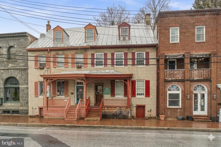 Located on Main Street in Old Ellicott City, this office/mixed-use commercial property offers exceptional visibility and consistent exposure to both vehicular and pedestrian traffic in one of Howard County’s most recognizable destinations. Zoned HC - Historic Commercial, the property has a wide range of permissible uses. The first-floor office space features a lobby/reception area, two private offices or work areas, and an additional storage room that could serve as a kitchen, break room, or an additional office. A half bathroom is also included on the main level, making the space well-suited for professional, retail, or service-based businesses. The upper level includes a two-story residential unit currently leased to a tenant who would prefer to remain, providing immediate rental income. This residence offers three bedrooms, a full bathroom, a kitchen, and a living room, creating a comfortable and functional living space. This space could easily be converted into additional office space, if desired. Additional value is found in the cellar/basement level, which is presently leased to a neighboring restaurant for supplemental storage. With multiple income streams, flexible zoning, and a prime Main Street location, this property presents a unique investment opportunity in one of Howard County’s most iconic and heavily visited historic districts. Key capital components including windows, roof, HVAC, and water heater are in good working order. Please reach out for additional details on this opportunity.