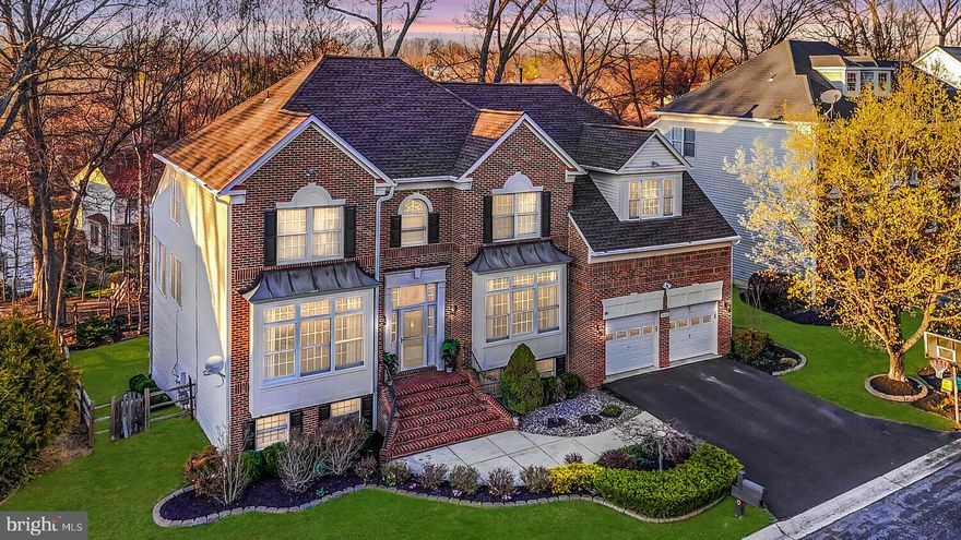 Stunning luxurious brick colonial home with custom upgrades, situated on a beautifully maintained cul-de-sac in the highly sought-after Potomac Grove Community. Boasting over 6,200 square feet of total living space spread across three finished levels, this home offers both luxury and comfort for everyday living at its finest. The main level showcases refinished custom walnut hardwood floors throughout, complemented by a sunken formal living and dining room. The powder room has been elegantly updated. A grand family room with soaring two-story ceilings and a cozy wood-burning fireplace provides the perfect gathering space as the rear of the home is adorned with windows almost entirely allowing abundant natural light to enter throughout. Adjacent to the family room, you'll find a versatile study or additional sitting area. Also on the main level, is a dedicated home office for privacy.

The heart of the home, the newly renovated gourmet kitchen features custom cabinetry, Bosch stainless steel appliances, elegant quartz countertops, tile backsplash and a peninsula perfect for breakfast bar seating. The eat-in breakfast room area leads to your large deck, offering peaceful views of the wooded & private backyard. A mudroom with updated front-load washer & dryer feature custom built-in storage & cabinet space and garage access completes the main floor.

The upper level is home to the spacious primary suite, which boasts a grand double-door entrance with vaulted ceilings. The bedroom includes a cozy sitting area, an oversized walk-in closet, and a luxurious freshly renovated en-suite bath with double vanities, a walk-in glass and tile shower, and a modern freestanding tub for a spa-like experience everyday. The secondary bedrooms are generously sized, with one of them featuring en-suite style complete with its own private bathroom, while the other bedrooms share an adjoining spacious full bathroom.

The fully finished lower level offers a 5th bedroom and full bathroom, ideal for a guest, in-law or au-pair suite. The expansive recreation room features massive soaring ceilings suitable for anything from golf simulators to provides walk-out access to the backyard, while a bonus room offers an ideal home fitness studio space, additional storage or flexible living space. The home has been meticulously maintained, with an upscale brand new primary bath renovation, freshly refinished rear deck, newer carpeting on the second and lower levels, an updated water heater, and energy-efficient Nest thermostats. Custom fresh paint and new window treatments throughout the home add a touch of style. New epoxy finished garage floors, EV charging, custom lighting, refinished railings & balusters, ceiling fans, and modern fixtures throughout add to the vast list of upgrades.

This stunning property is move-in ready and perfectly located just minutes from shopping, dining, parks, and schools, with easy access to all major commuter routes and public transportation. Don't miss your chance to make this exceptional property your new home!