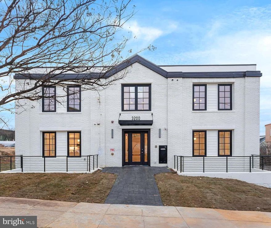 Welcome to The Santmeyers, a newly reimagined boutique apartment community offering spacious and thoughtfully designed residences. Unit 104 is a 1-bedroom, 1-bathroom apartment located in a beautifully repurposed building originally constructed as a school in 1924. Spanning 652 square feet, this light-filled unit features twelve oversized windows. Three hall closets offer generous storage leading into the open kitchen and living area, ideal for entertaining. The kitchen includes stainless steel appliances, an induction range, black fixtures, wood shaker cabinetry, and a large stainless-steel sink. Off the living room is a powder room and access to all three sizable bedrooms. The primary suite boasts a walk-in closet, an oversized shower with dual shower heads, and a double vanity. The second and third bedrooms share a full bath with a separate water closet. Enjoy the comfort of your new home and the convenience of nearby shops and dining along Rhode Island Avenue, including Zeke’s Coffee, Emma’s Torch, and Rita’s Italian Ice & Custard. Schedule a tour today and experience life at The Santmeyers. Photo of model unit 104